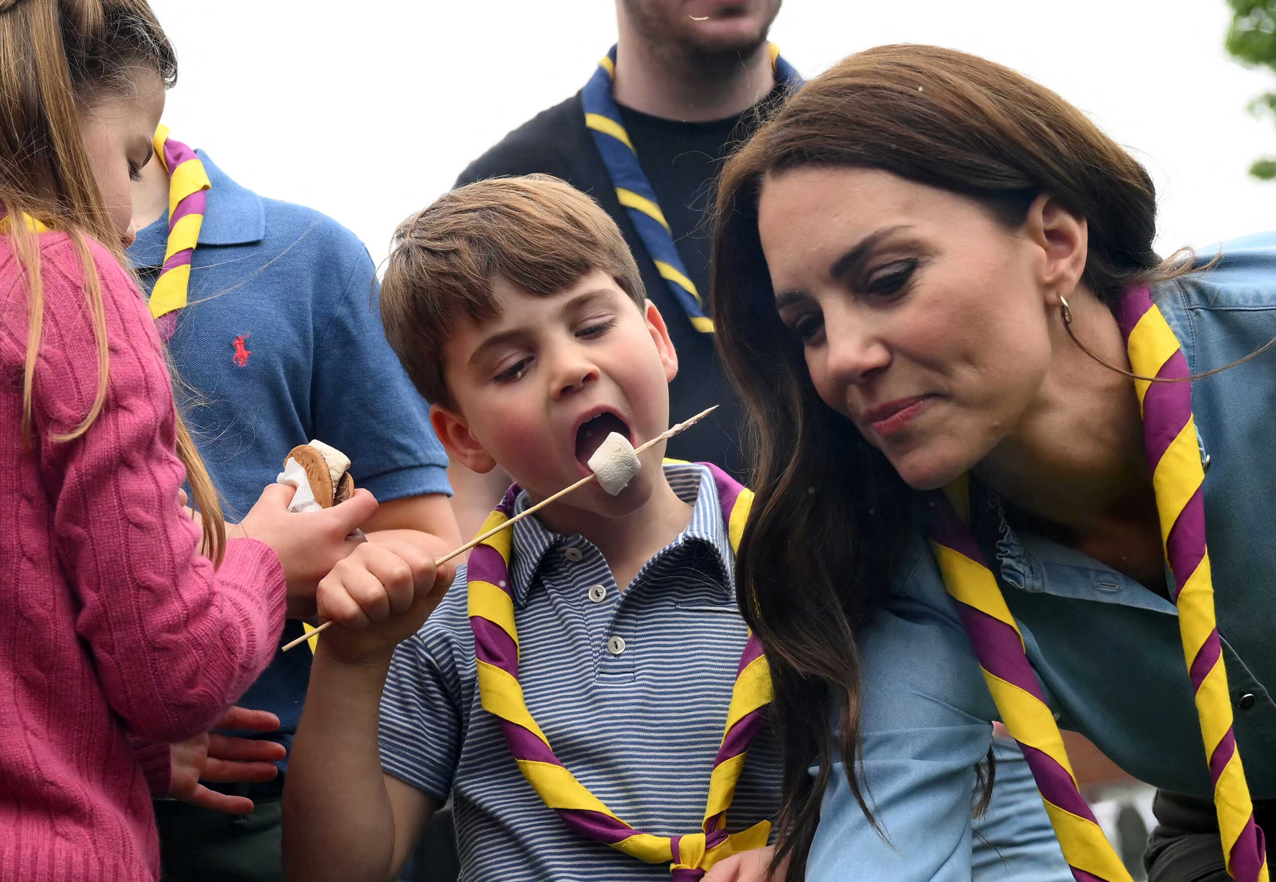 Britain's Prince Louis of Wales eats a toasted marshmallow next to Britain's Catherine, Princess of Wales, as they take part in the Big Help Out, during a visit to the 3rd Upton Scouts Hut in Slough, west of London, Britain, May 8, 2023. Daniel Leal