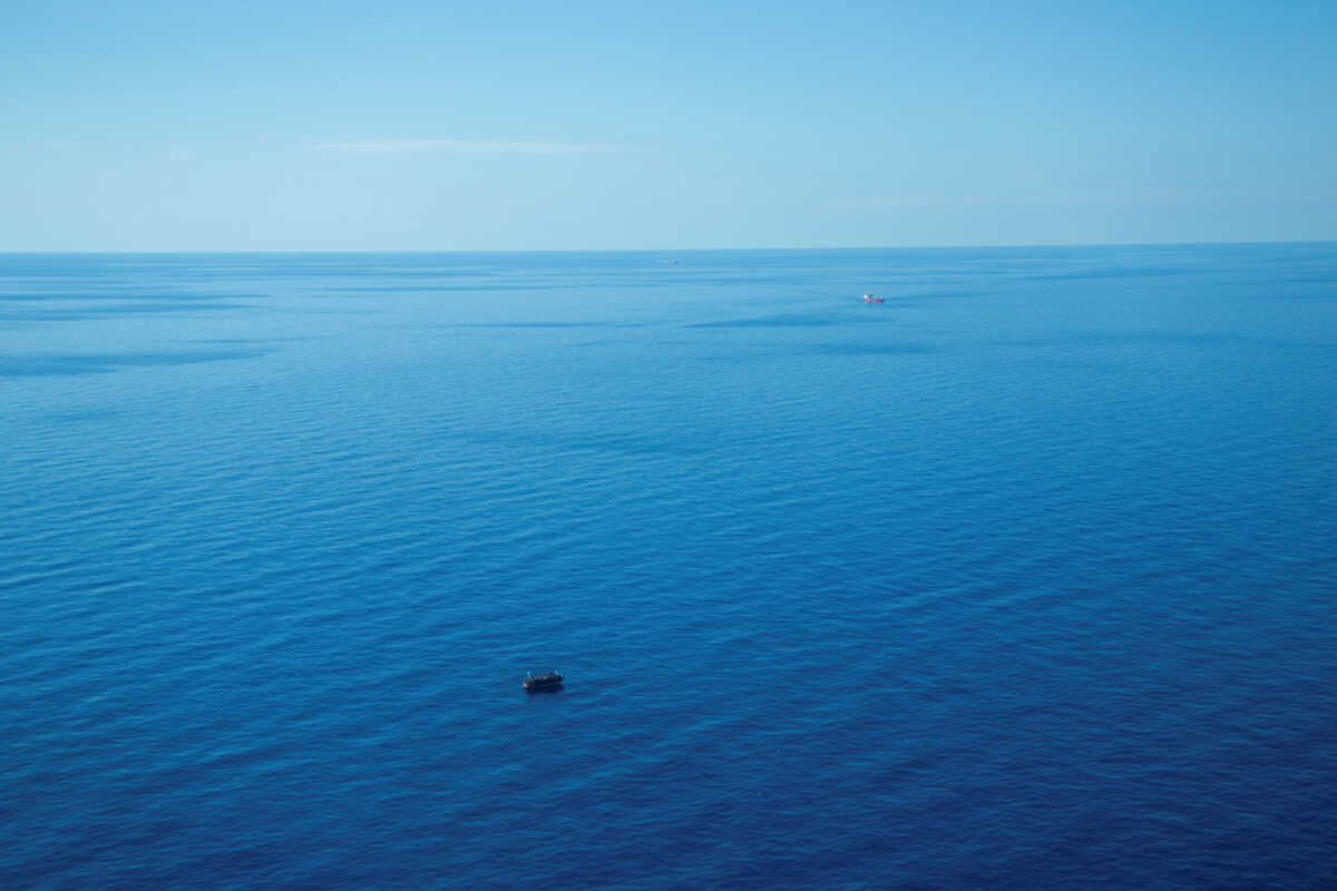 The boat in distress with about 400 people on board is pictured with Merchant vessels Pericles and FMT Urla in the background, in Central Mediterranean Sea in this handout obtained by Reuters on April 10, 2023. Giacomo Zorzi