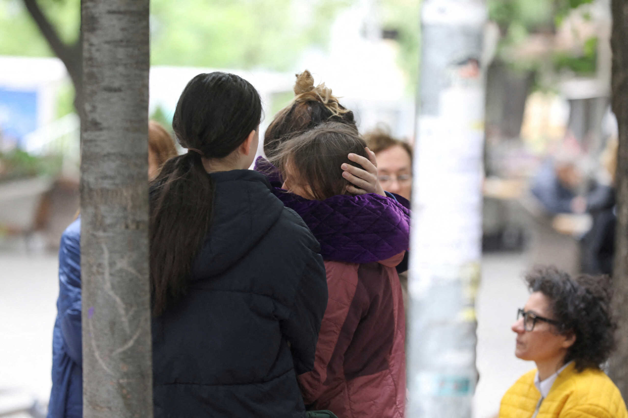 People react after a 14-year-old boy opened fire on other students and security guards at a school in downtown Belgrade, Serbia, May 3, 2023. REUTERS