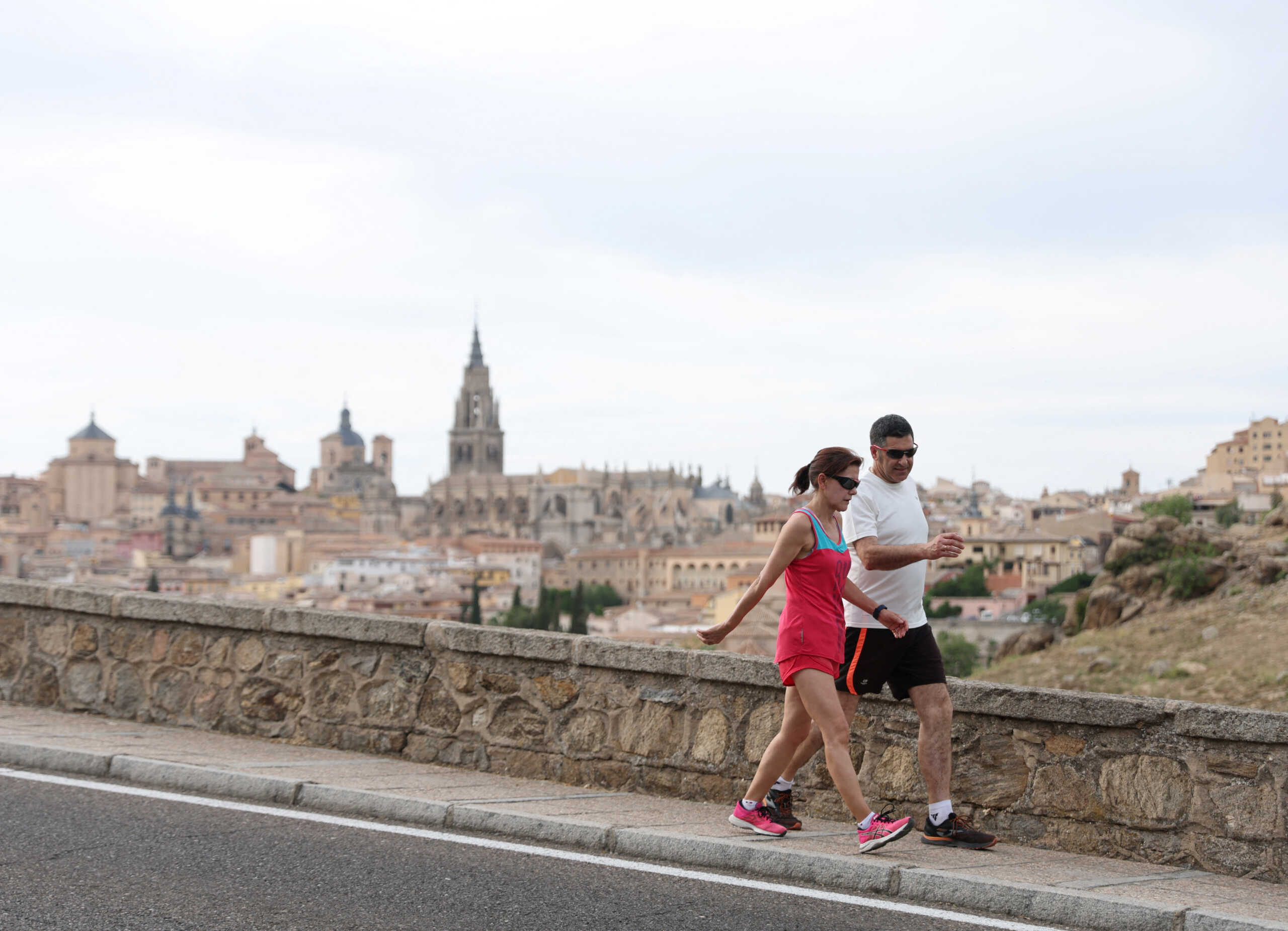 People exercise under the strong sun during scorching summer temperatures in spring in Toledo, Spain April 28, 2023. REUTERS