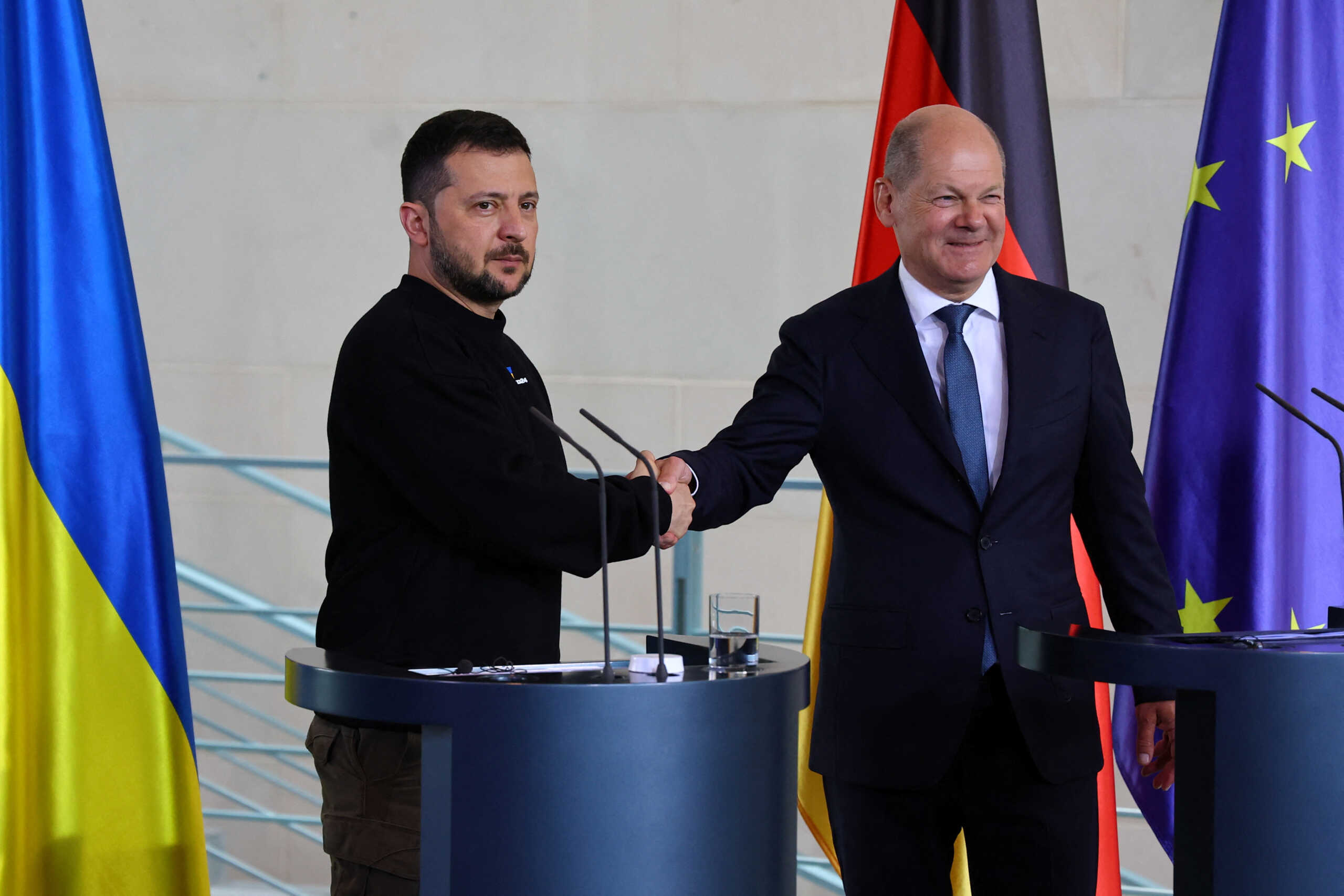 German Chancellor Olaf Scholz and Ukraine's President Volodymyr Zelenskiy shake hands as they speak to the media following their closed door meeting at the Chancellery in Berlin, Germany, May 14, 2023. REUTERS