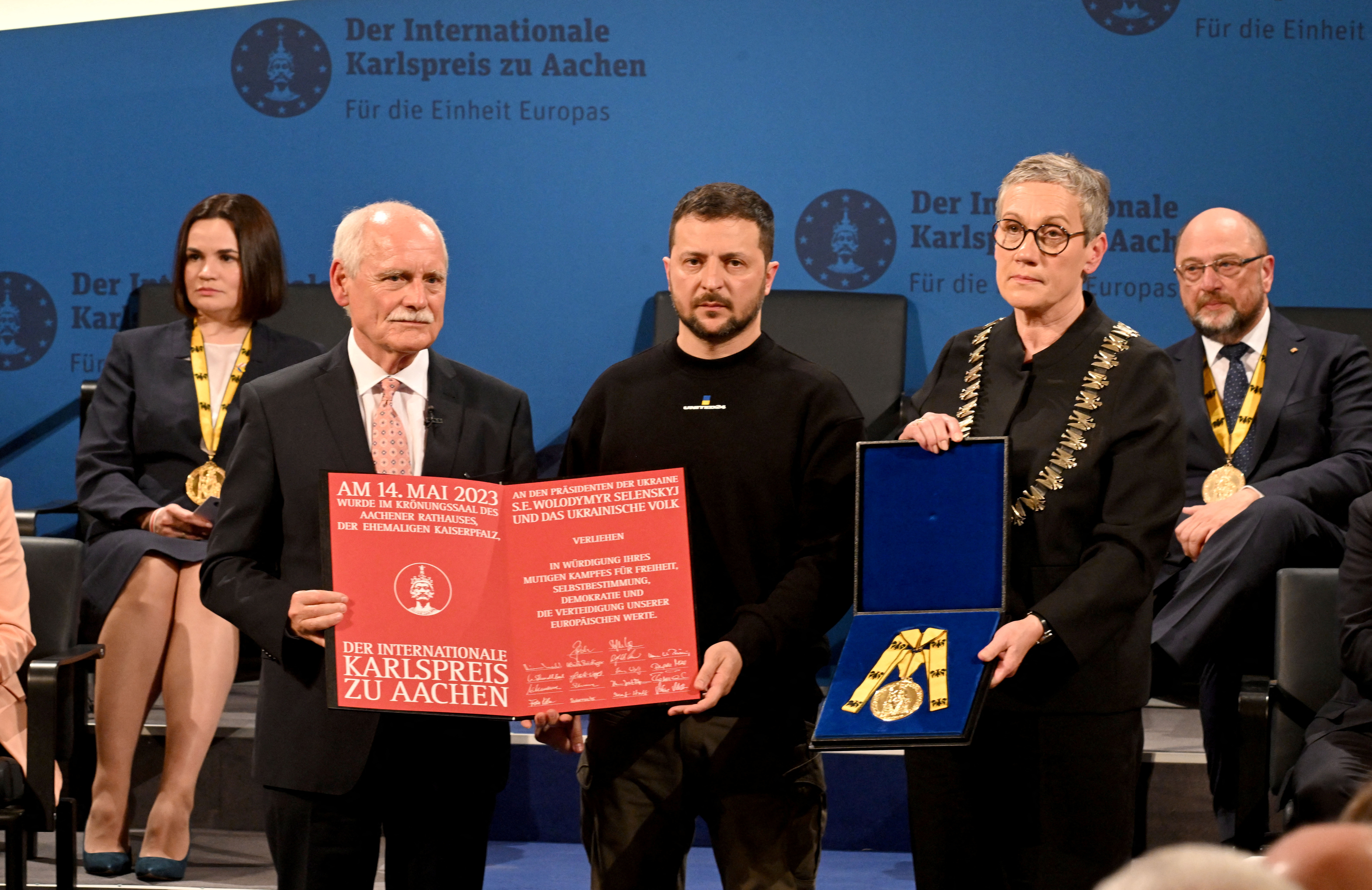 Ukraine's President Volodymyr Zelenskiy is awarded the International Charlemagne Prize of Aachen 2023 by Juergen Linden, chairman of the Charlemagne Prize board of directors and Aachen's mayor Sibylle Keupen as Belarusian opposition leader and former laureate of the International Charlemagne Prize of Aachen (Karlspreis) Sviatlana?Tsikhanouskaya, and German politician and former laureate of the International Charlemagne Prize of Aachen (Karlspreis) Martin Schulz look on, on May 14, 2023 in Aachen, western Germany. The International Charlemagne Prize of Aachen is the oldest and best-known prize awarded for work done in the service of European unification. Zelenskiy and the People of Ukraine were given the prize for "fighting to defend not only the sovereignty of their country and the lives of its citizens, but also Europe and European values".     INA FASSBENDER