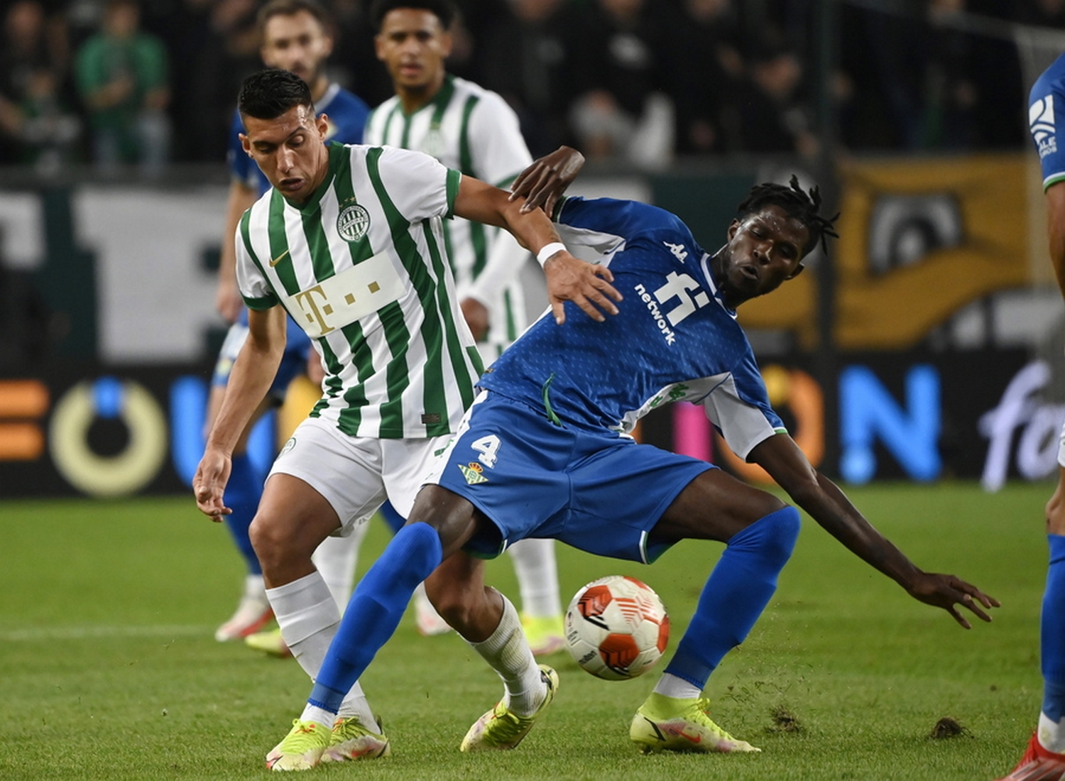 epa09498518 Paul Akouokou of Real Betis (R) in action against Myrto Uzoni of Ferencvaros TC during the UEFA  Europa League group G soccer match between Ferencvaros TC and Real Betis in Groupama Arena in Budapest, Hungary, 30 September 2021.  EPA