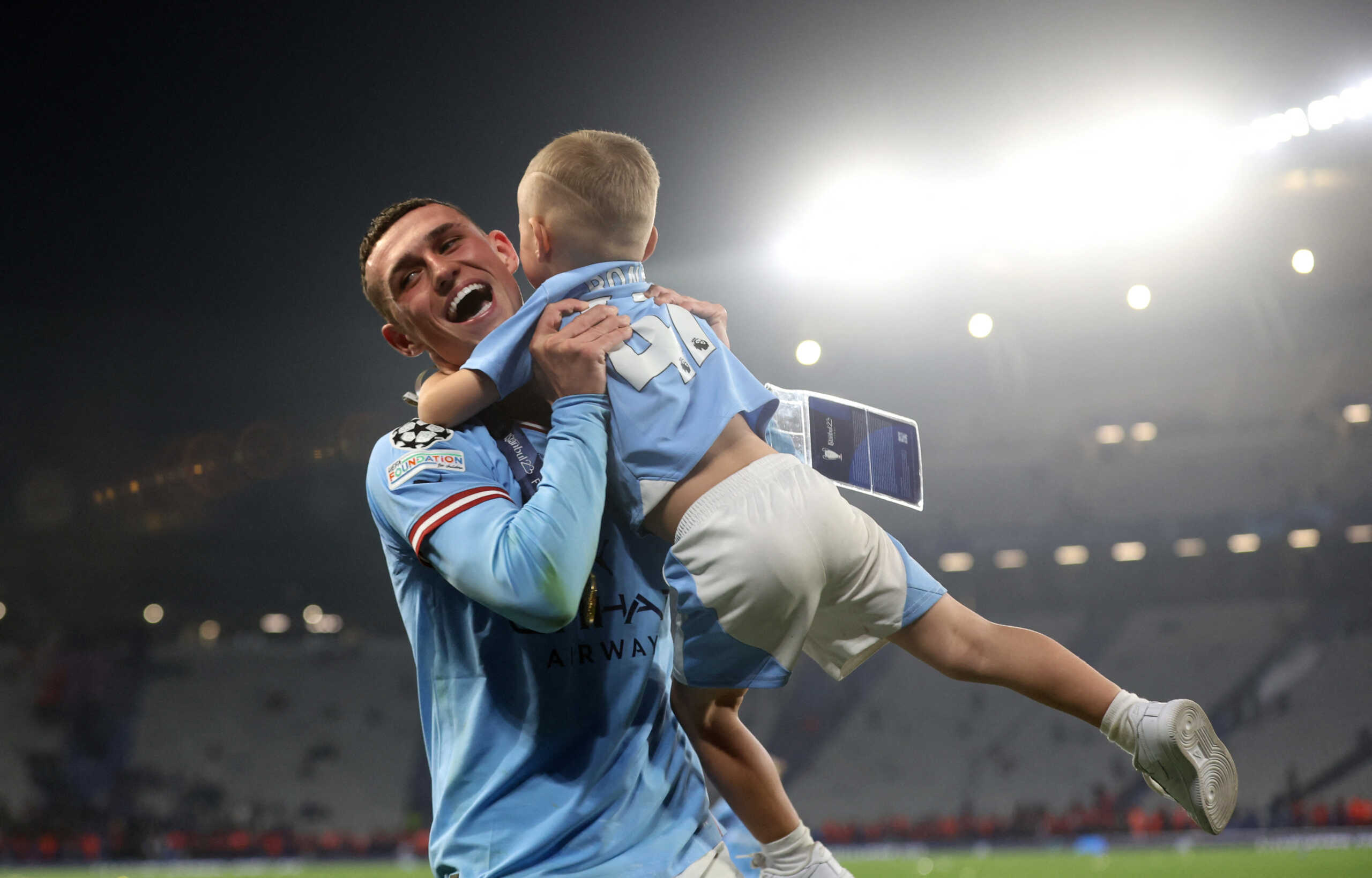 Soccer Football - Champions League Final - Manchester City v Inter Milan - Ataturk Olympic Stadium, Istanbul, Turkey - June 11, 2023 Manchester City's Phil Foden celebrates winning the Champions League with his son Ronnie REUTERS