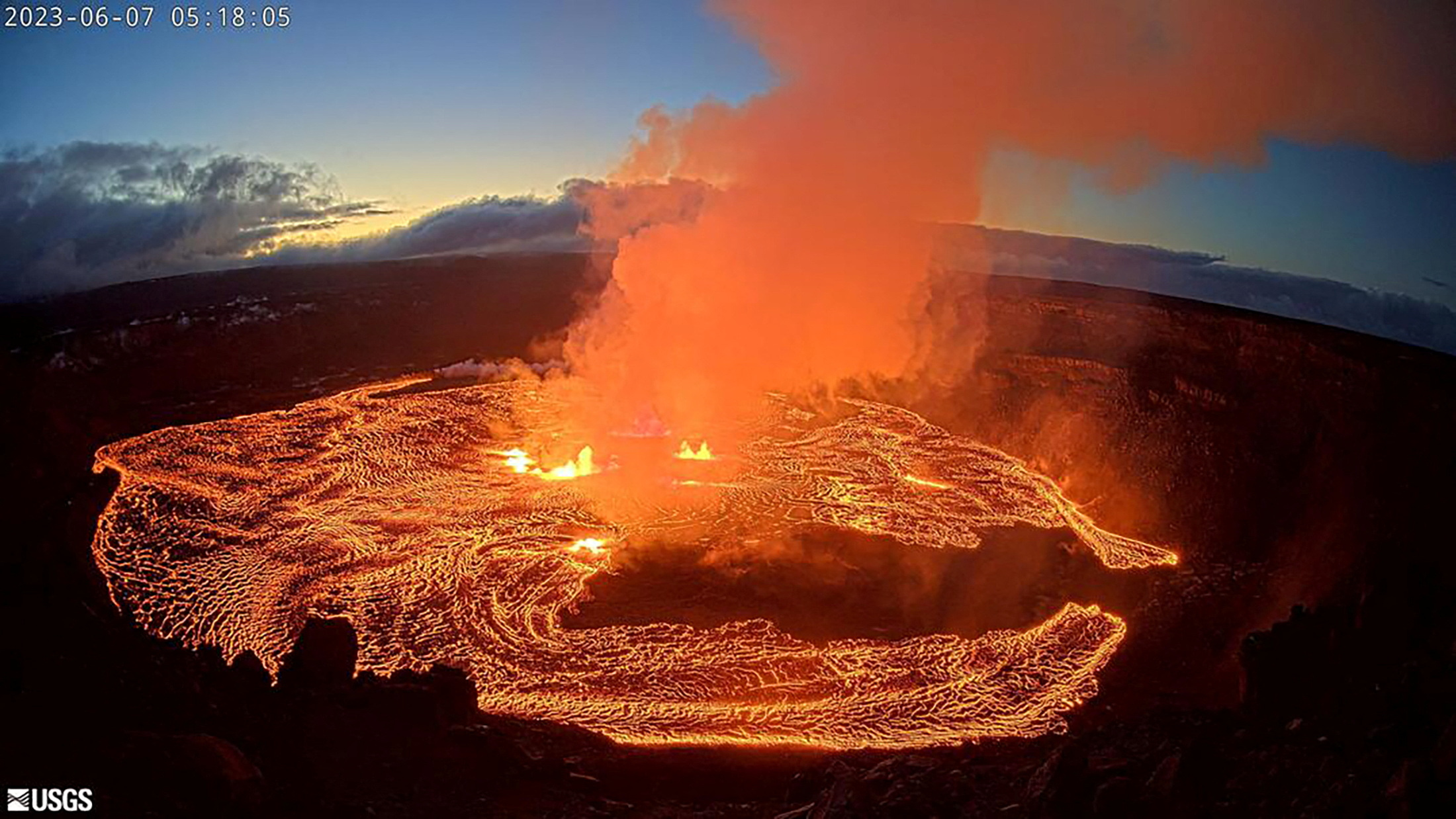 A lava lake forms at Halemaʻumaʻu as seen from the west rim of the Kilauea caldera during the volcano's eruption in Hawaii, U.S. June 7, 2023 in a still image from webcam video.    USGS