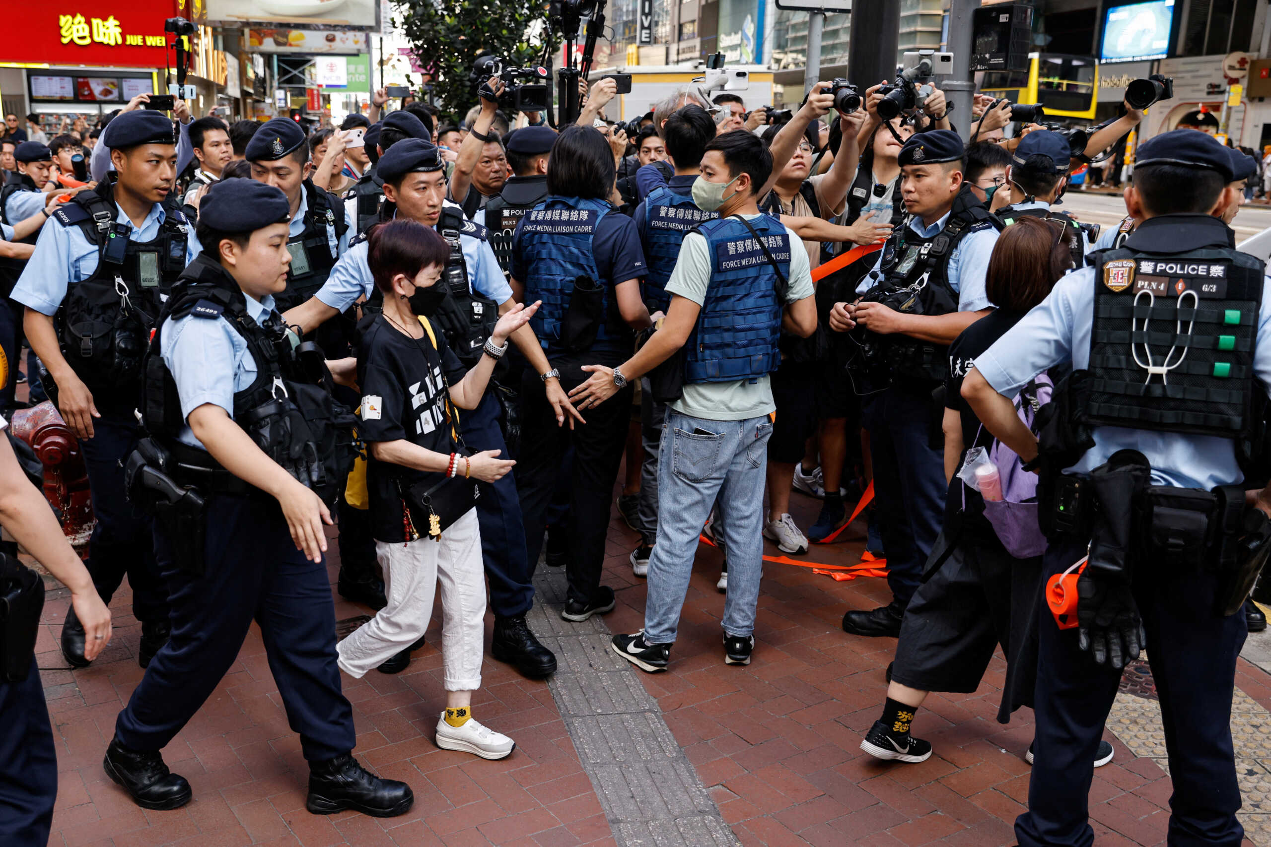 Police detain a person in downtown on the 34th anniversary of the 1989 Beijing's Tiananmen Square crackdown, near where the candlelight vigil is usually held, in Hong Kong, China June 4, 2023. REUTERS