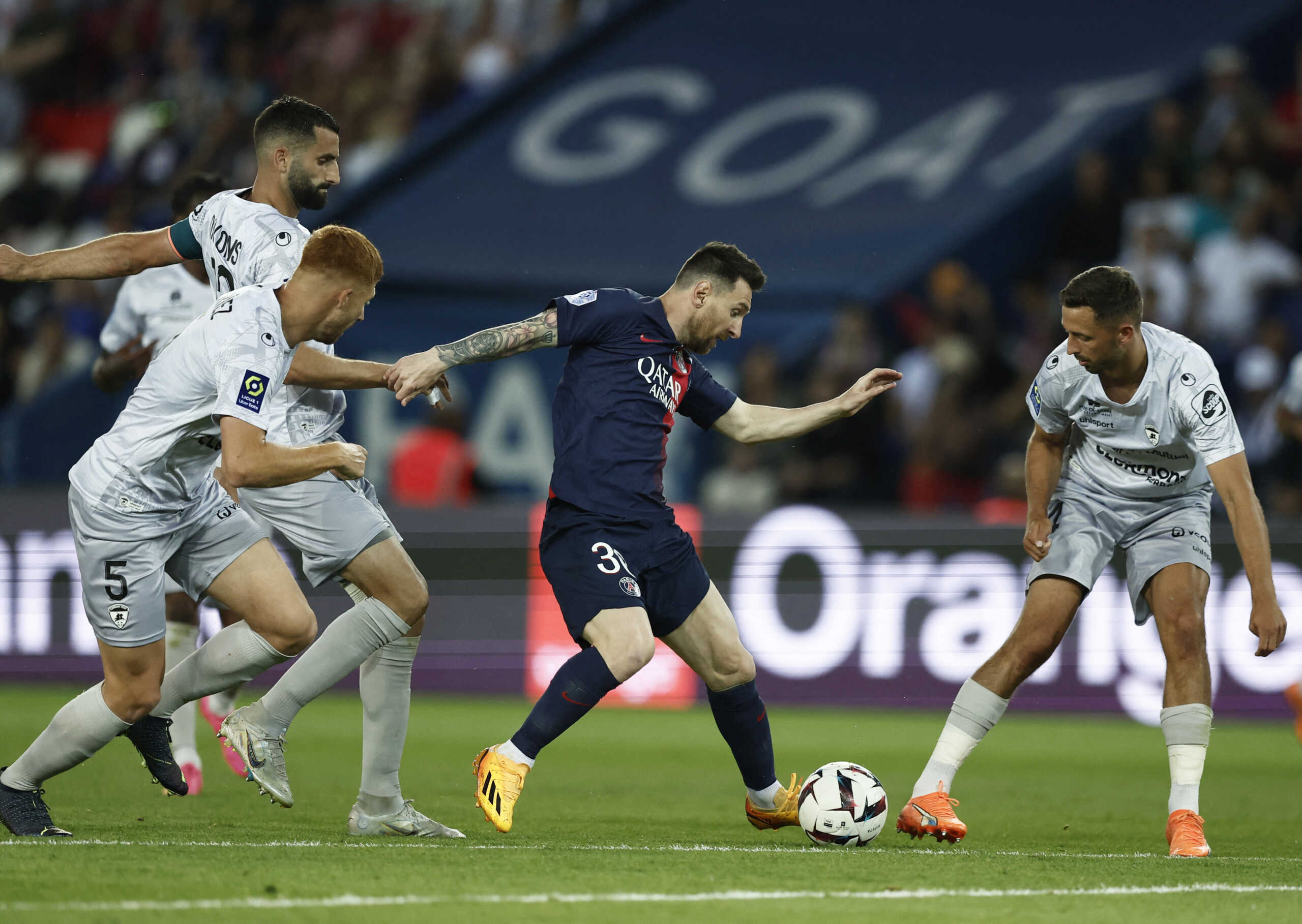 Soccer Football - Ligue 1 - Paris St Germain v Clermont - Parc de Princes, Paris, France - June 3, 2023  Paris St Germain's Lionel Messi in action with Clermont's Maximiliano Caufriez and Mateusz Wieteska REUTERS