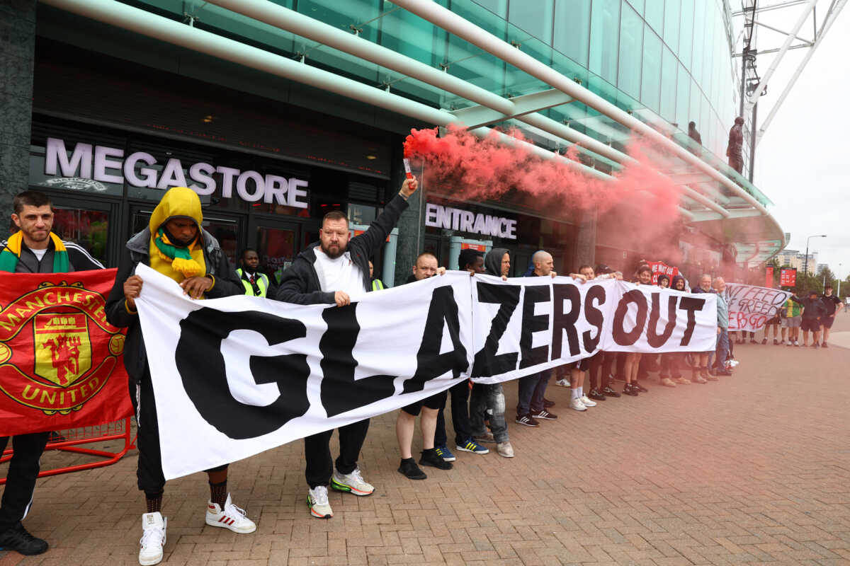 Soccer Football - Premier League - Manchester United Fans Protest - Old Trafford, Manchester, Britain - June 27, 2023 Manchester United fans display a banner in protest against the Glazer family’s ownership of the club REUTERS