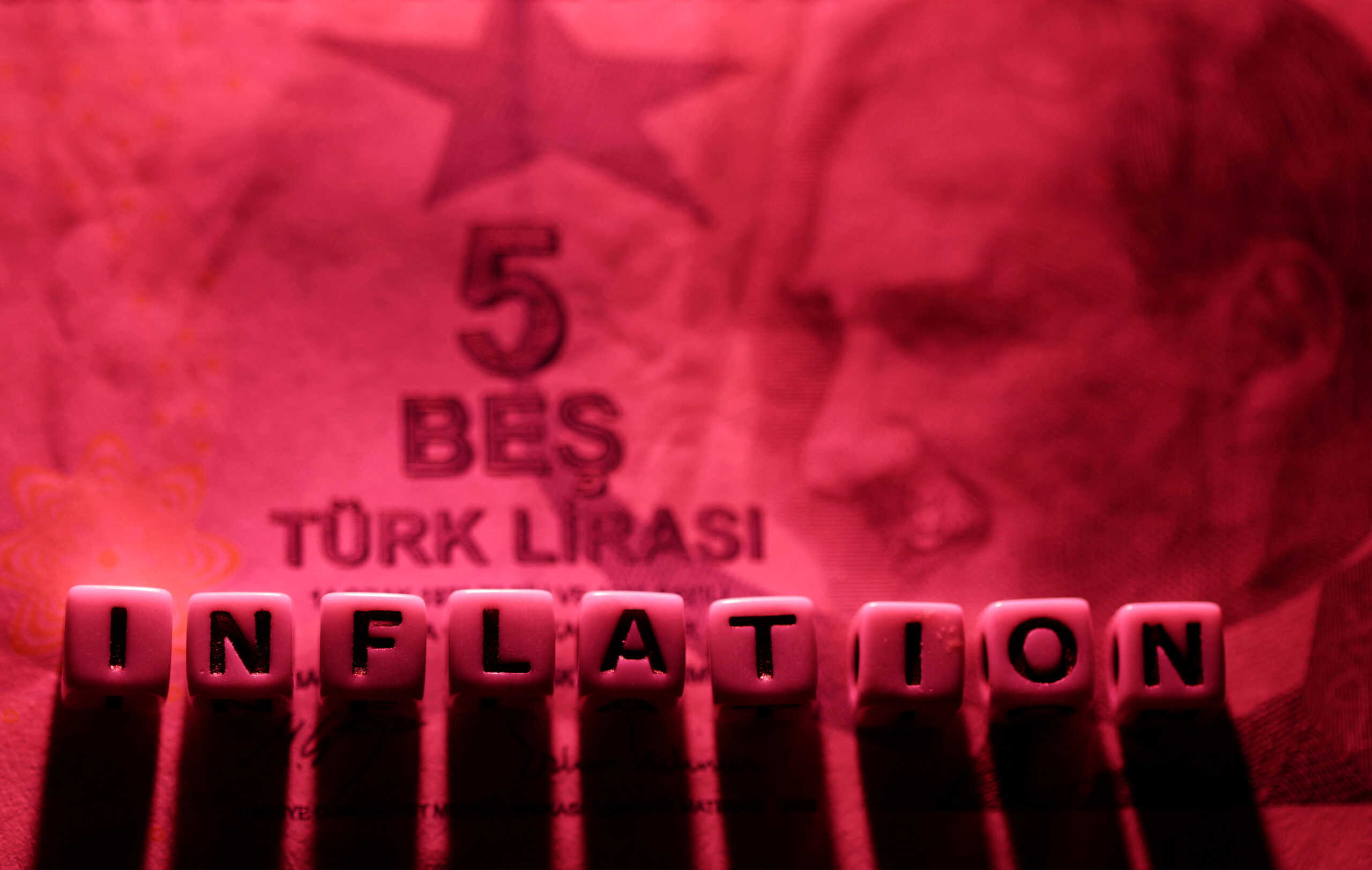 FILE PHOTO: Plastic letters arranged to read "Inflation" are placed on Turkish Lira banknote in this illustration taken, June 12, 2022. REUTERS
