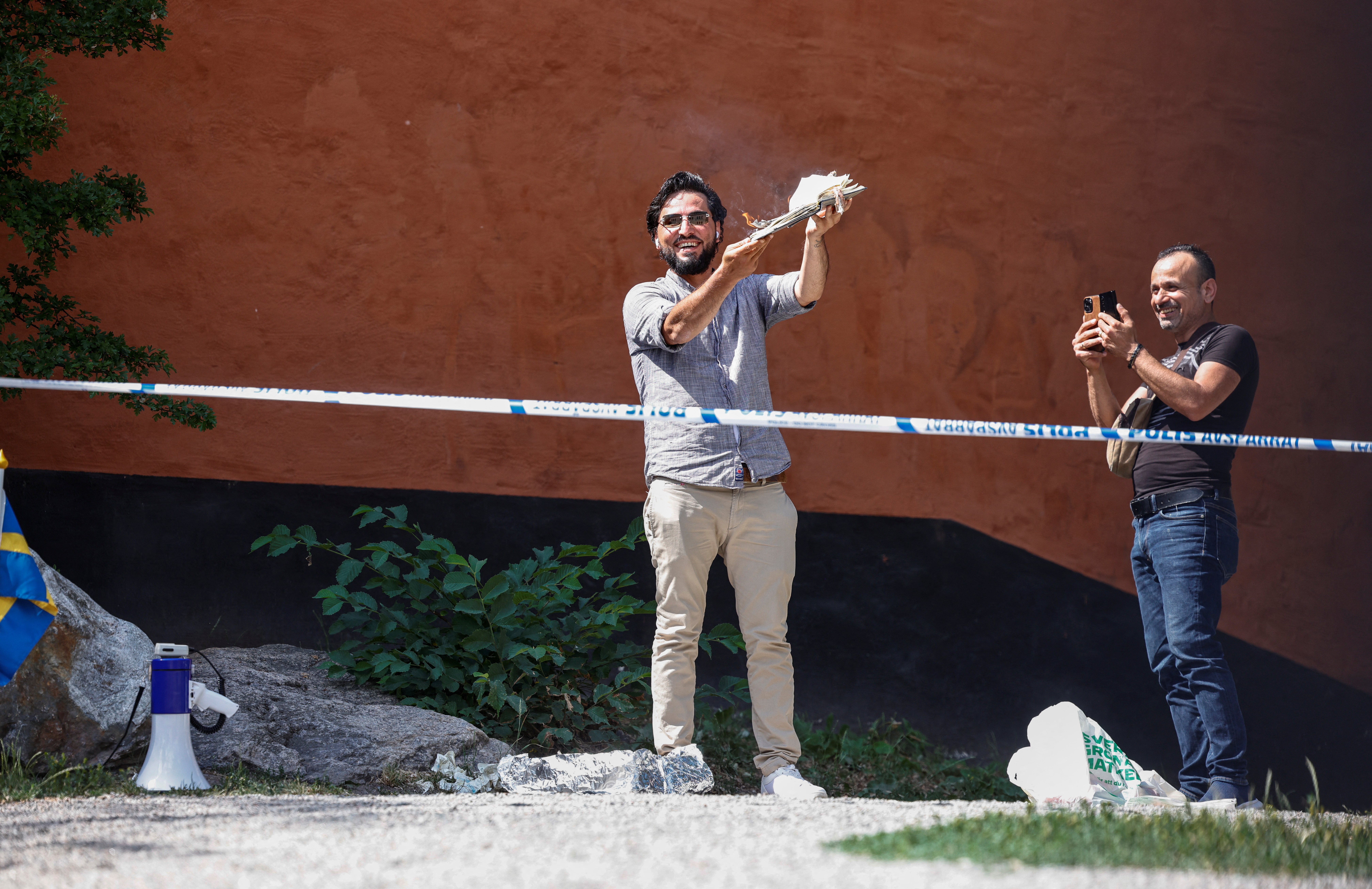 A demonstrator burns the Koran outside Stockholm's central mosque in Stockholm, Sweden June 28, 2023. TT News Agency