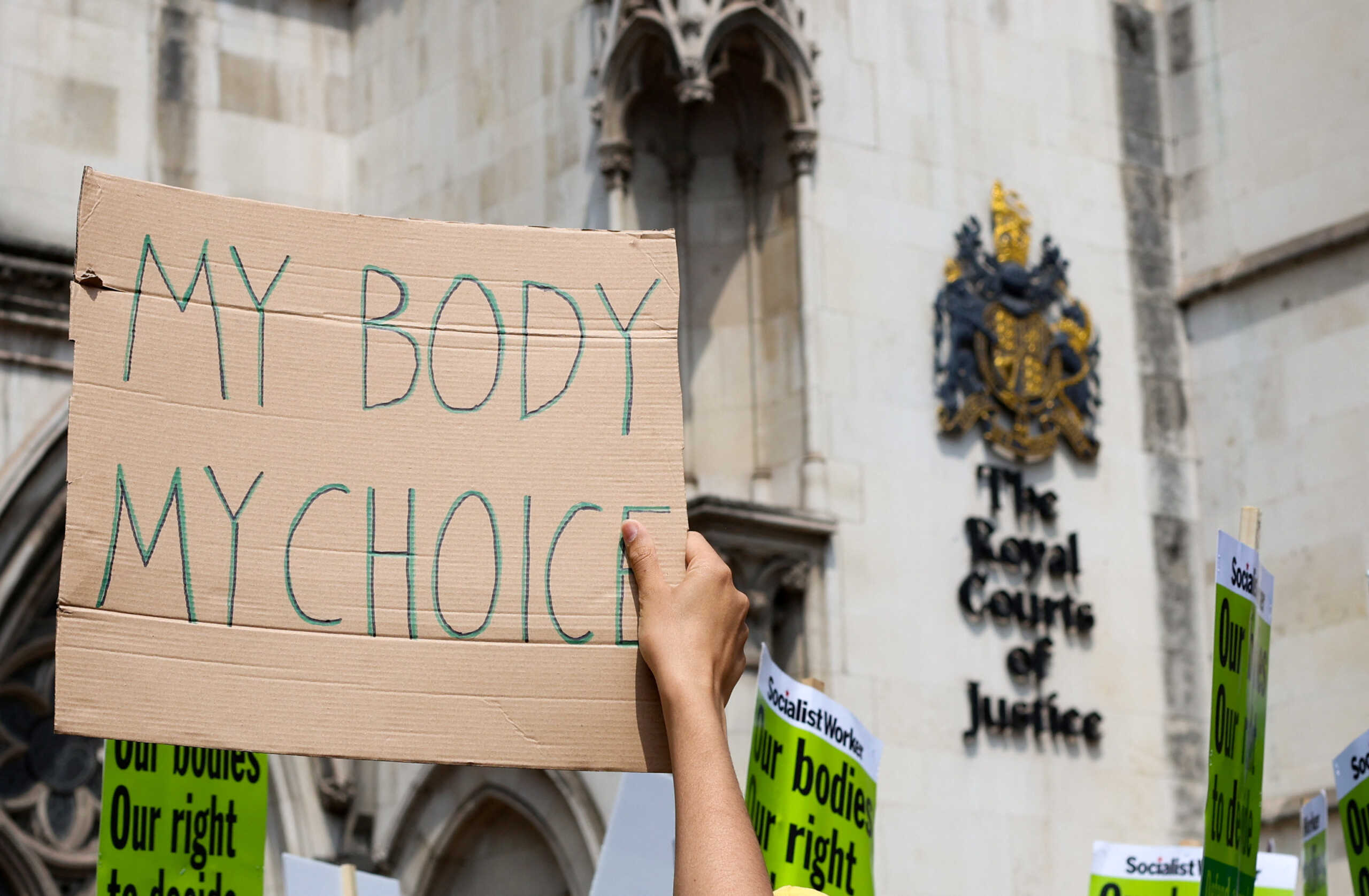A person holds a placard during a demonstration in support and solidarity of decriminalising abortion in the UK, outside the Royal Courts of Justice, in London, Britain June 17, 2023. REUTERS