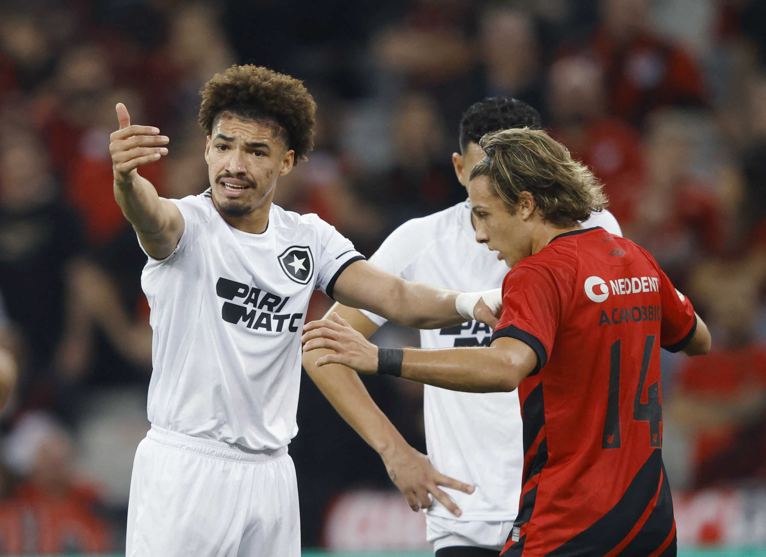 Soccer Football - Brasileiro Championship - Athletico Paranaense v Botafogo - Arena da Baixada, Curitiba, Brazil - June 3, 2023 Botafogo's Adryelson clashes with Athletico Paranaense's Agustin Canobbio REUTERS