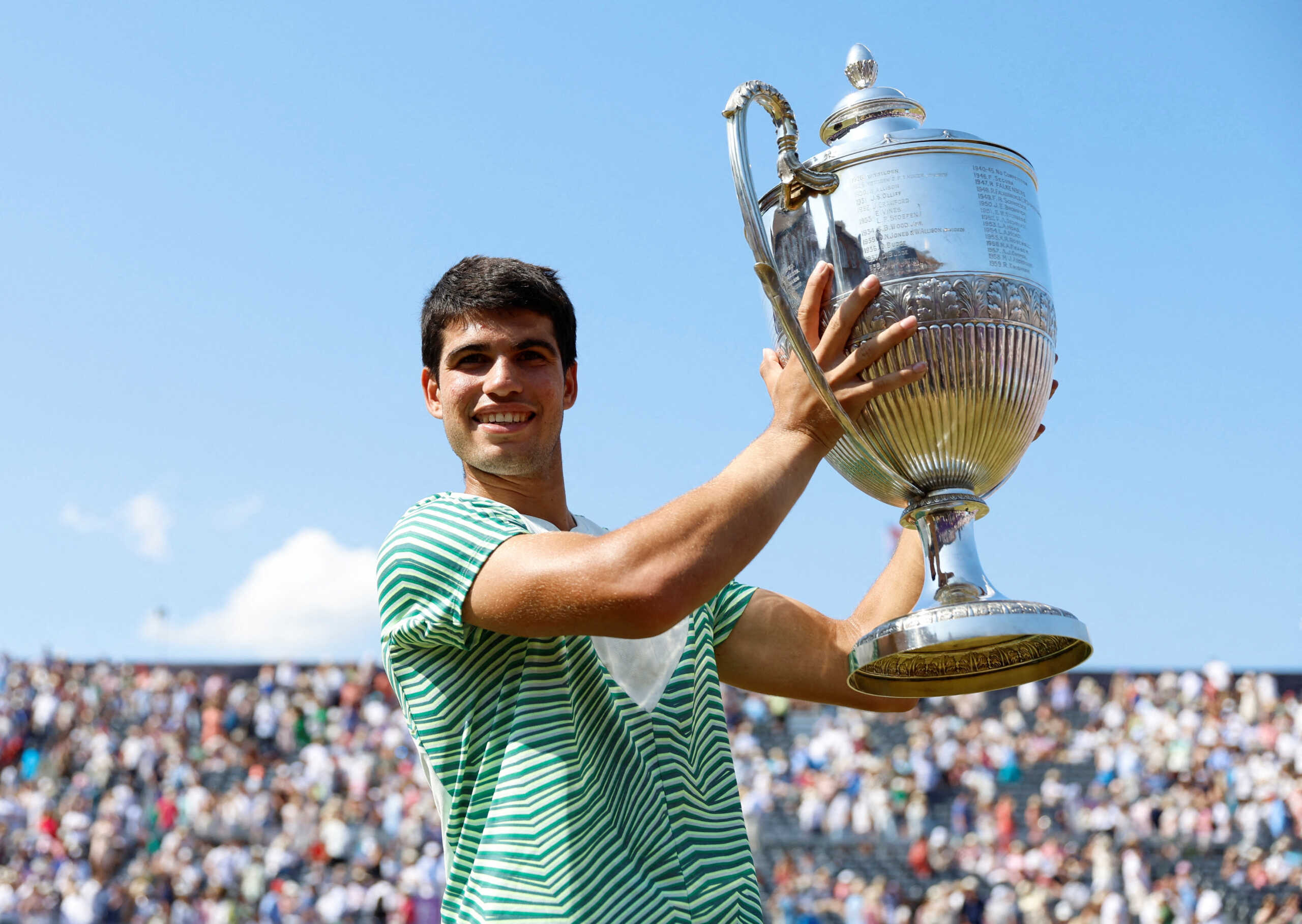 Tennis - ATP 500 - Queen's Club Championships - Queen's Club, London, Britain - June 25, 2023 Spain's Carlos Alcaraz celebrates with the trophy after winning his final match against Australia's Alex de Minaur Action Images via Reuters