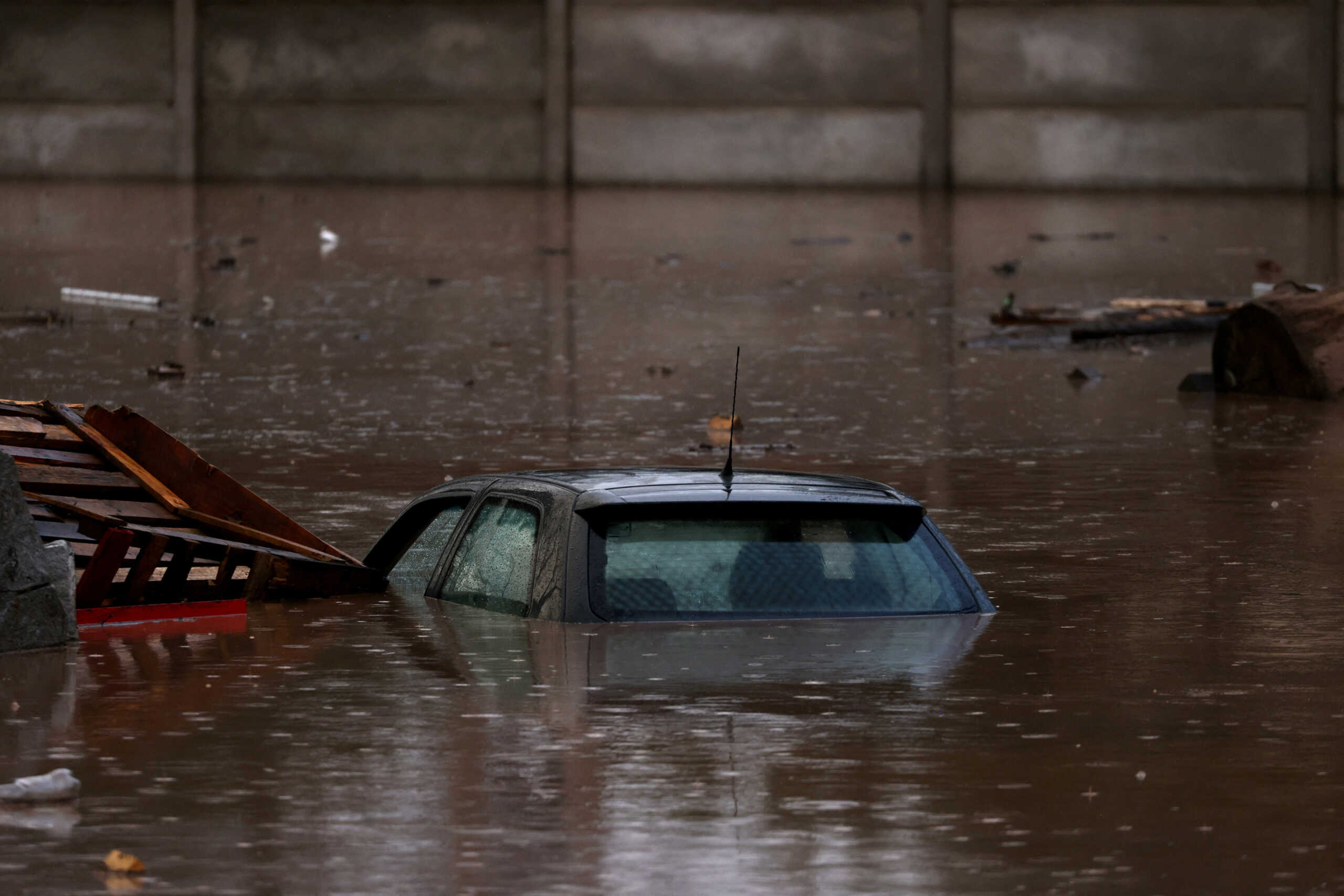 A car is submerged in floodwaters after heavy rains Santiago, Chile, June 23, 2023. REUTERS