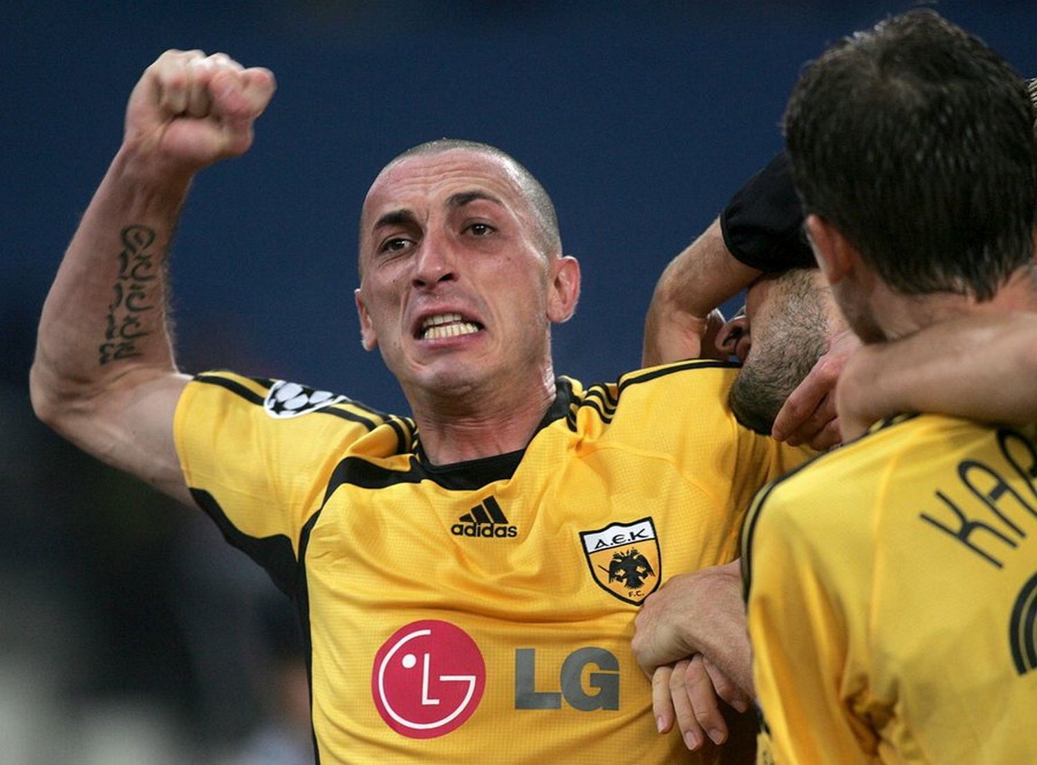 epa00853749 AEK's Athens Bruno Cirillo  celebrates after his team mate Nikos Liberopoulos scored against  Lille during their Group H, Champions League soccer match, in the Ollympic Stadium of Athens on Wednesday 1 November 2006  EPA