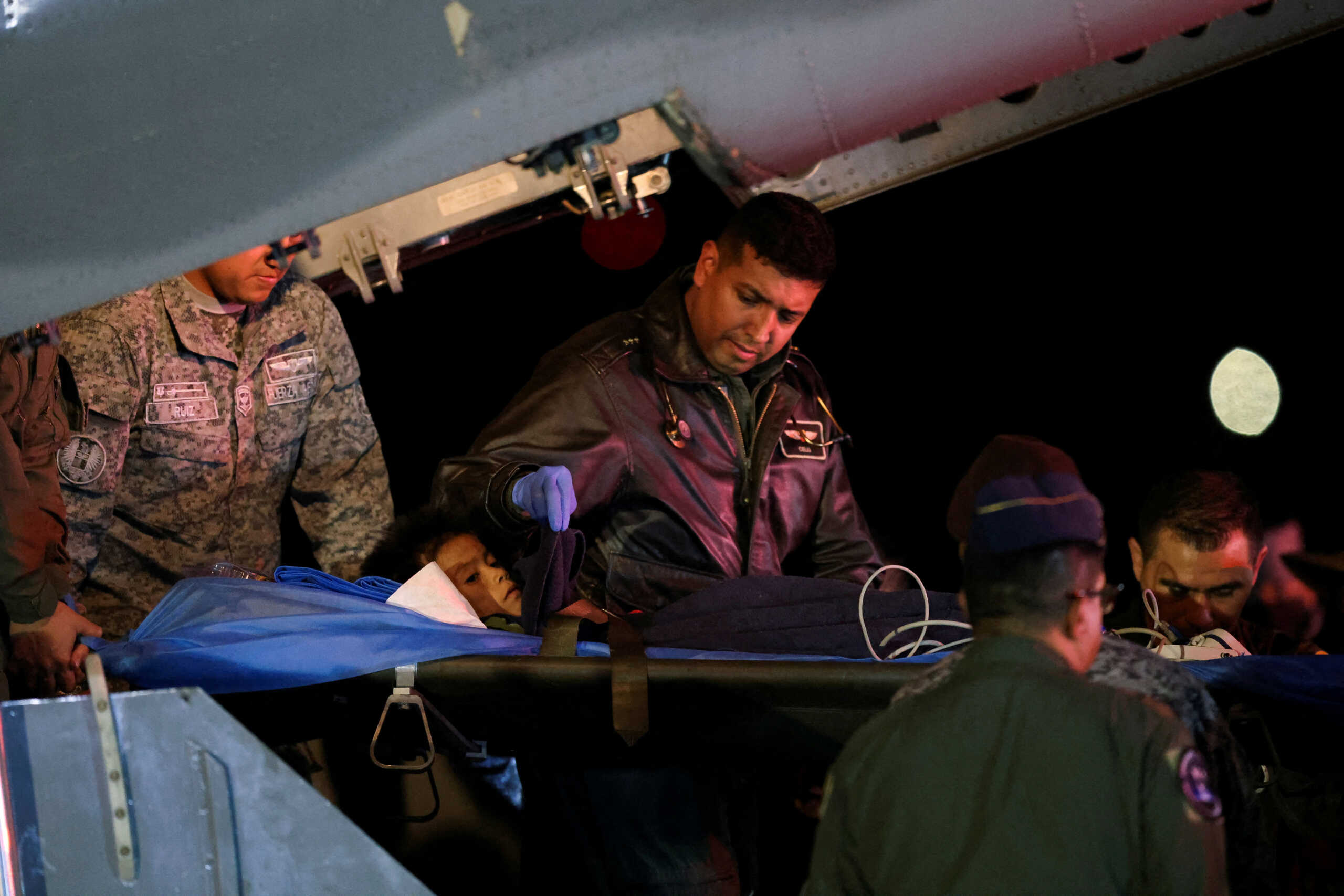 A child survivor from a Cessna 206 plane that crashed in thick jungle is carried on a gurney after arriving from San Jose del Guaviare, at the CATAM military airbase, in Bogota, Colombia, June 10, 2023. REUTERS