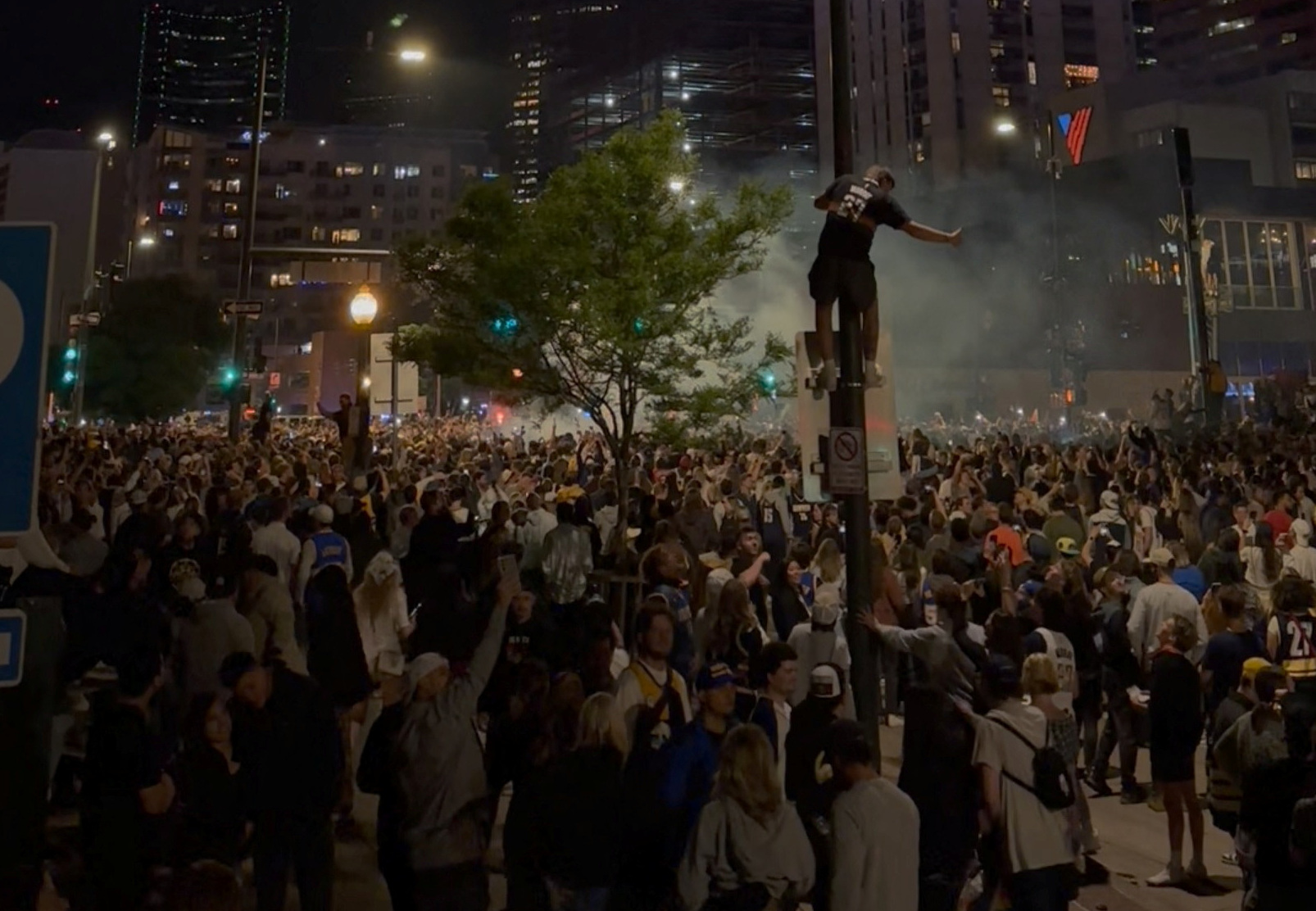 A view of crowd on the streets and fireworks during the celebration after Denver Nuggets won NBA title, in Downtown Denver, Colorado,U.S. June 12, 2023, in this screen grab obtained from a social media video. Zain Dada