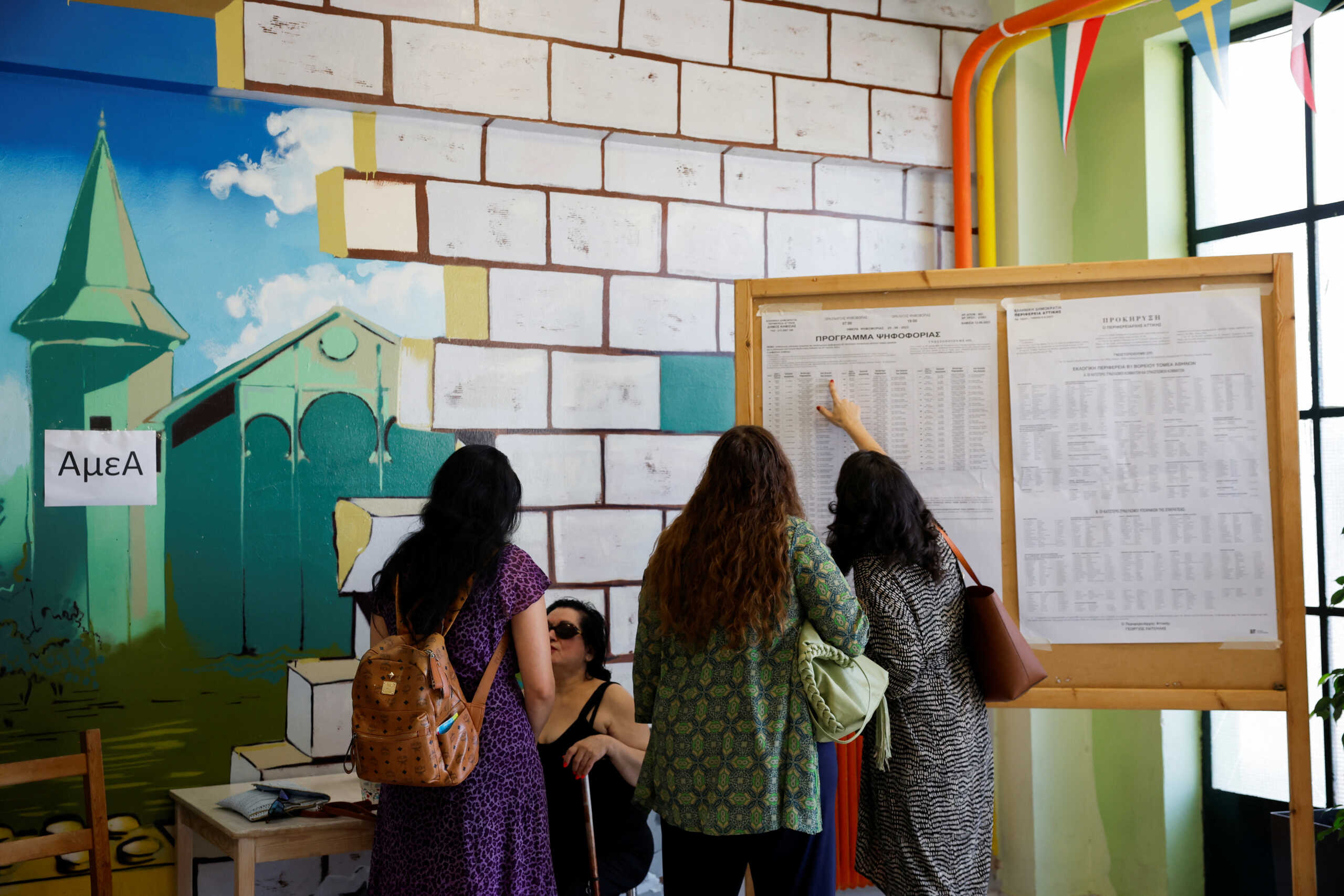 People gather at a polling station, during the general election, in Athens, Greece, June 25, 2023. REUTERS