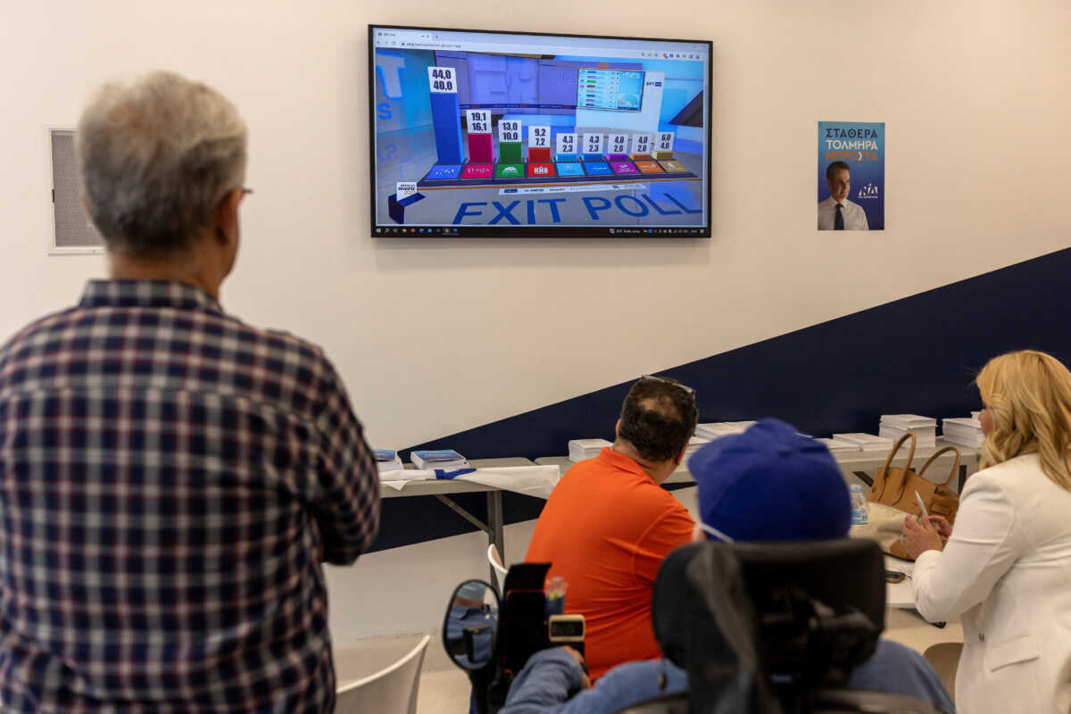 Supporters of New Democracy conservative party look at the announcement of the first exit polls at the party's main election kiosk, on the day of the general election, in Athens, Greece, June 25, 2023. REUTERS