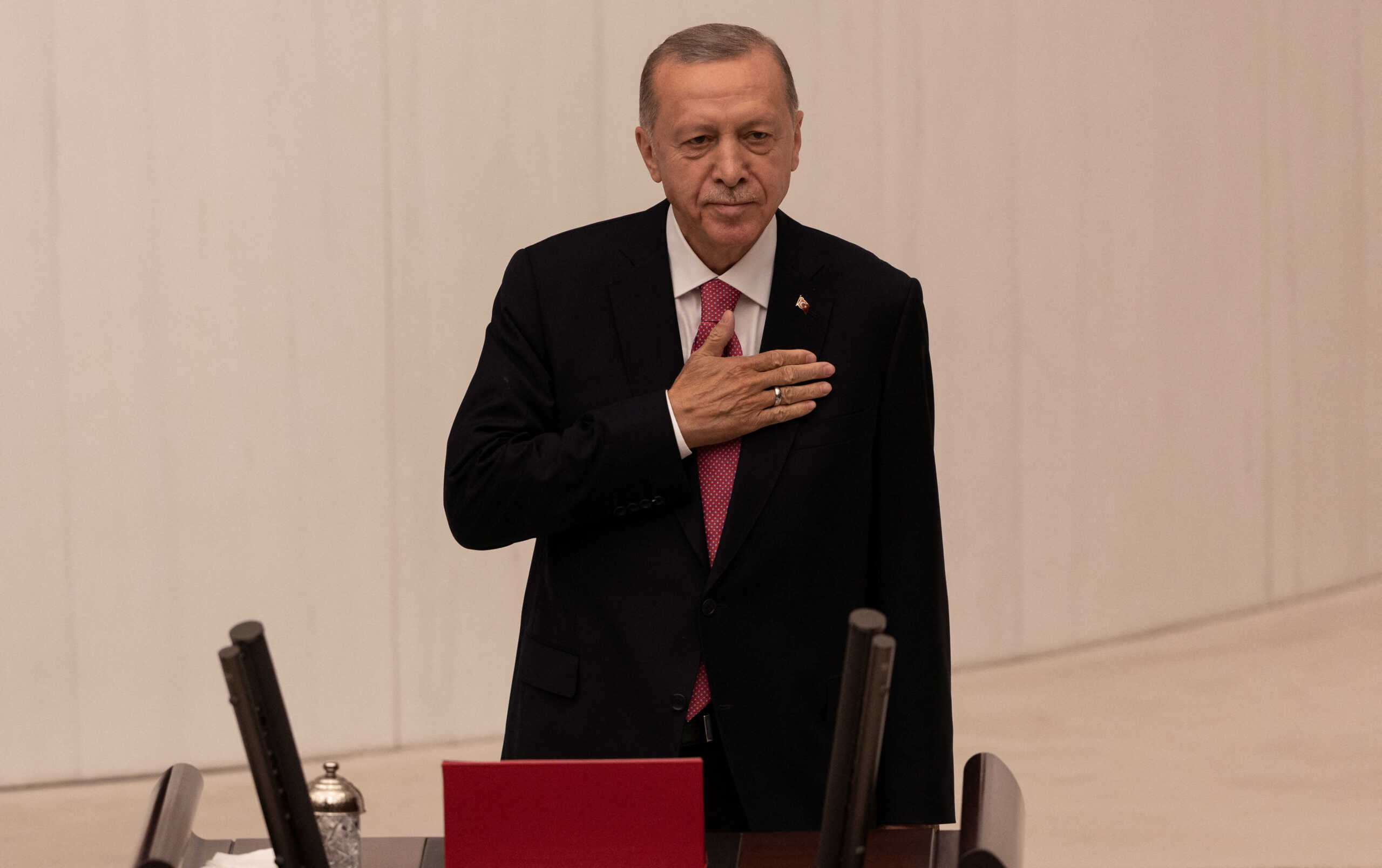 Turkish President Tayyip Erdogan greets members of the parliament and guests as he arrives to take his oath after his election win in Ankara, Turkey, June 3, 2023. REUTERS