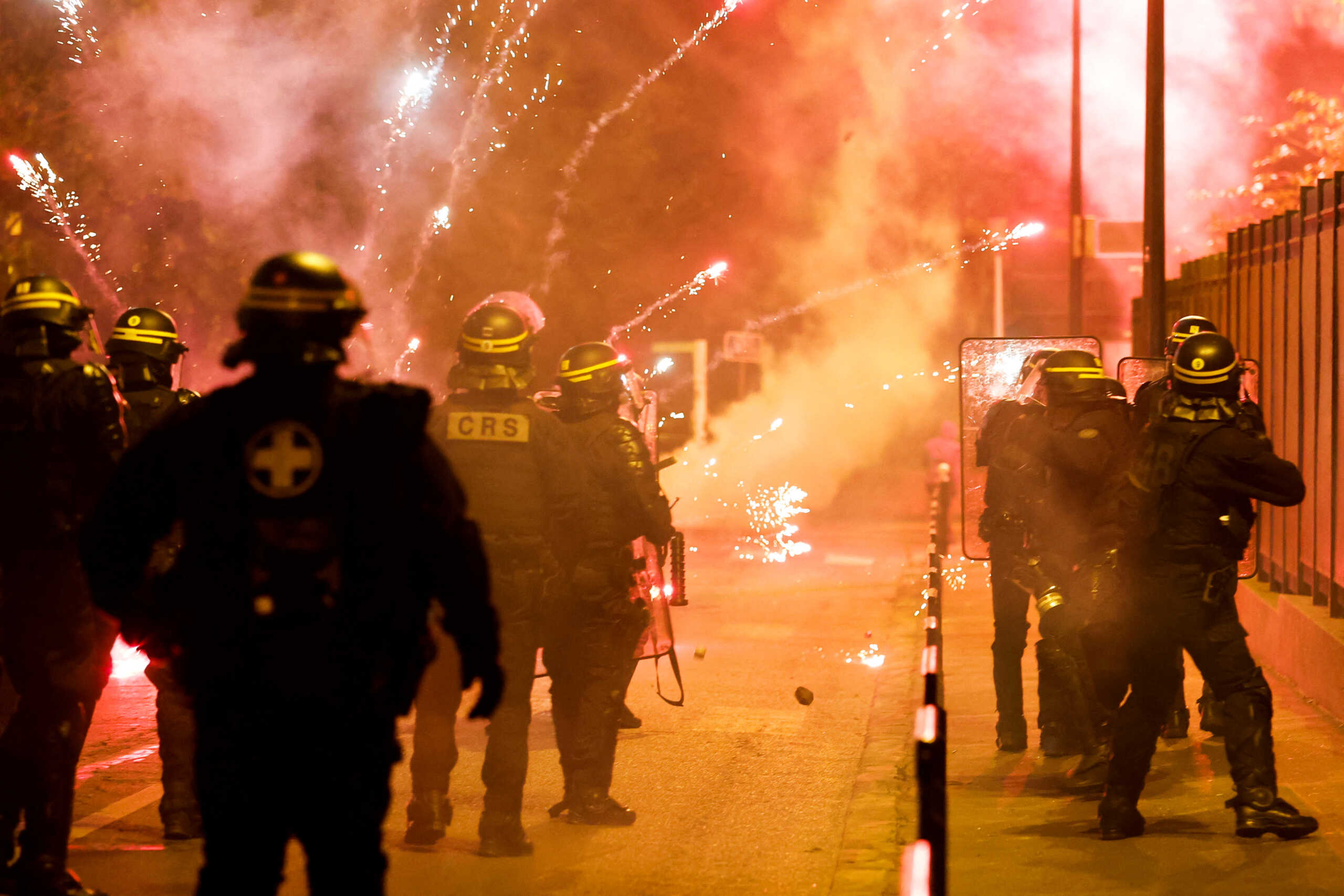 French police stand in position as fireworks go off during clashes with youth, after the death of Nahel, a 17-year-old teenager killed by a French police officer during a traffic stop, in Nanterre, Paris suburb, France, June 30, 2023. REUTERS