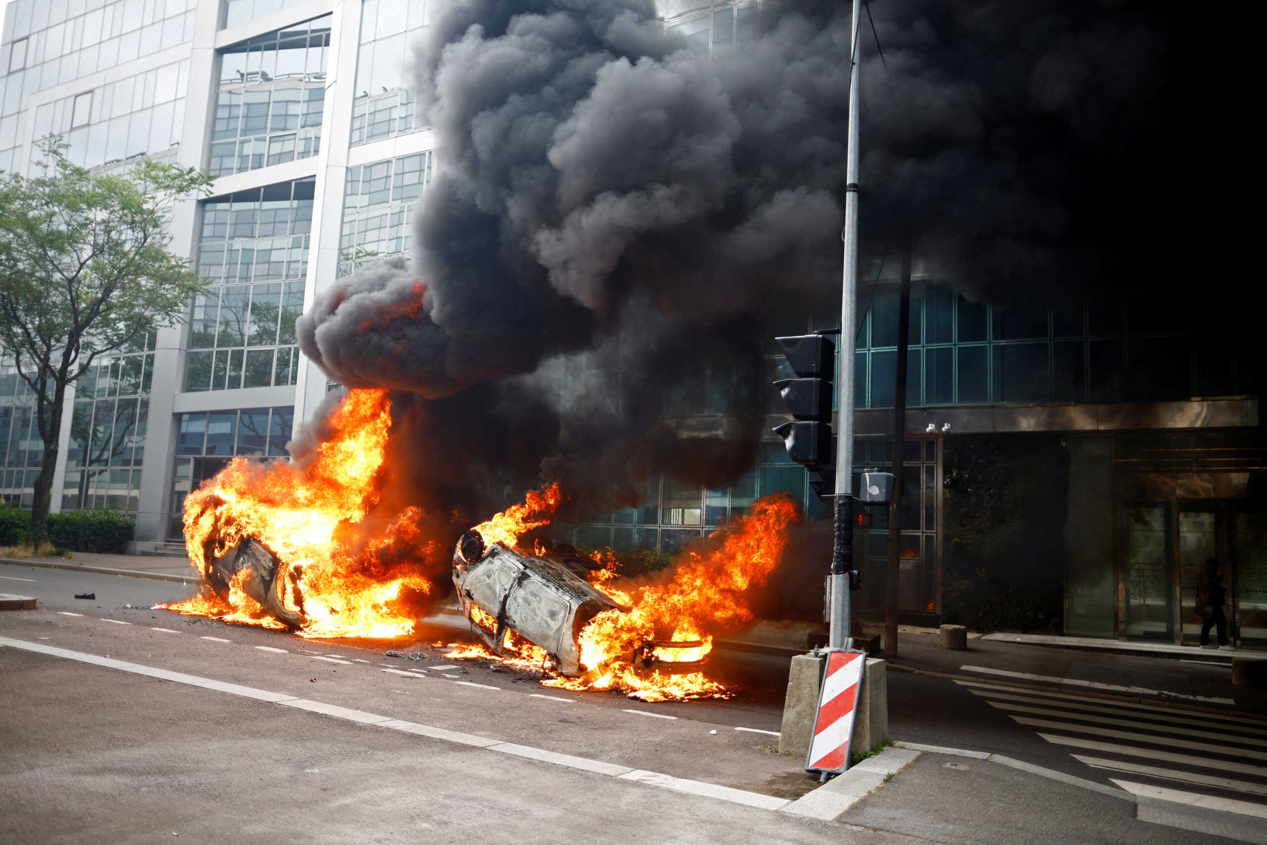 Burning vehicles are seen in a street amid clashes between protesters and police during a march in tribute to Nahel, a 17-year-old teenager killed by a French police officer during a traffic stop, in Nanterre, Paris suburb, France, June 29, 2023.    REUTERS