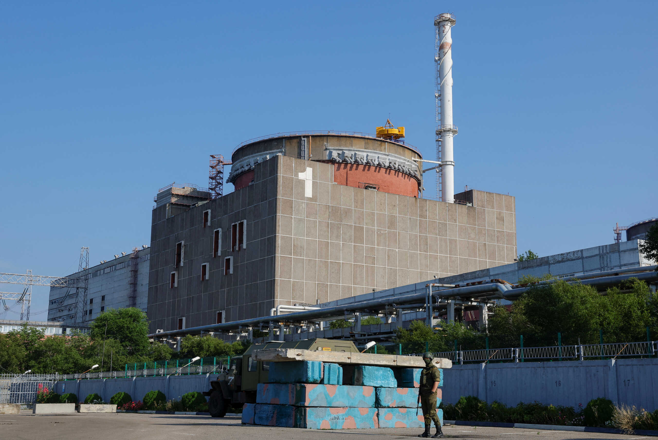 A Russian service member stands guard at a checkpoint near the Zaporizhzhia Nuclear Power Plant before the arrival of the International Atomic Energy Agency (IAEA) expert mission in the course of Russia-Ukraine conflict outside Enerhodar in the Zaporizhzhia region, Russian-controlled Ukraine, June 15, 2023. REUTERS