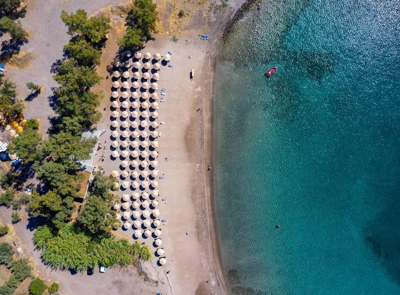 Aerial top down view to the popular beach of Klima with turquoise sea on the island of Aegina, Greece
