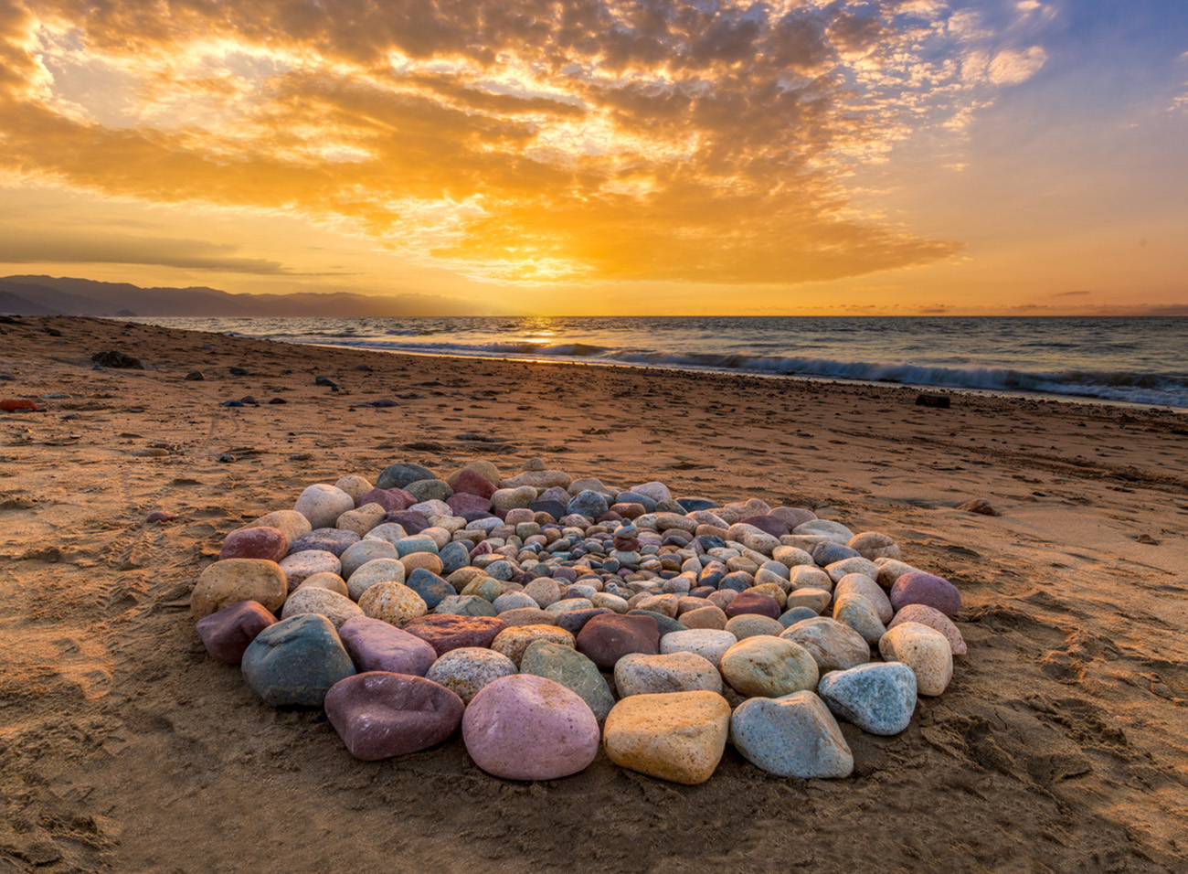 Sacred Ritual Stones For Spiritual Ceremony Are Are Arranged In A Circle During Sunset On The Beach