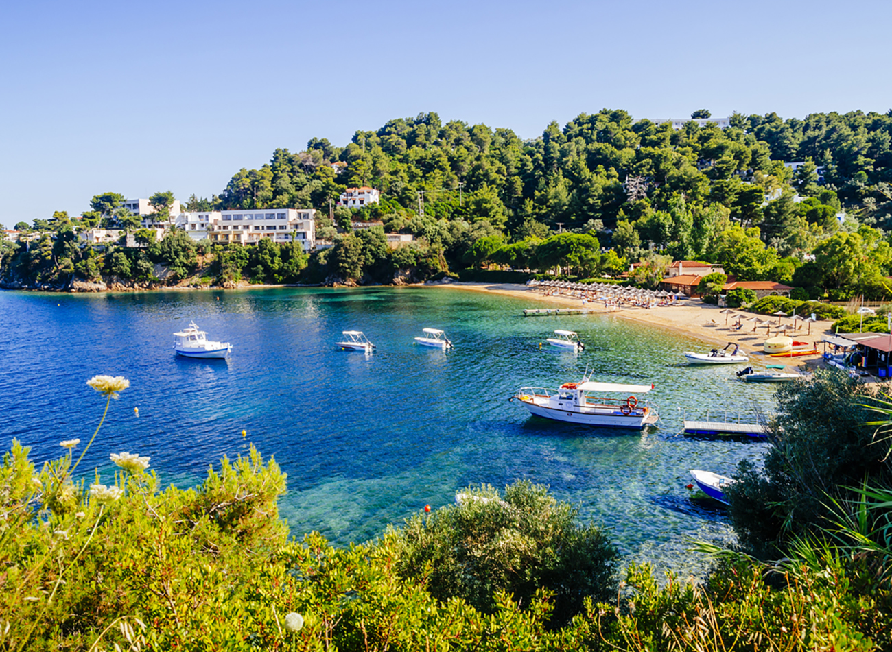 Troulos beach, Skiathos island, Greece. Beautiful vivid panorama view of blue aegean sea coast from wild cliff.  Summer holiday vacation tour to greek islands.