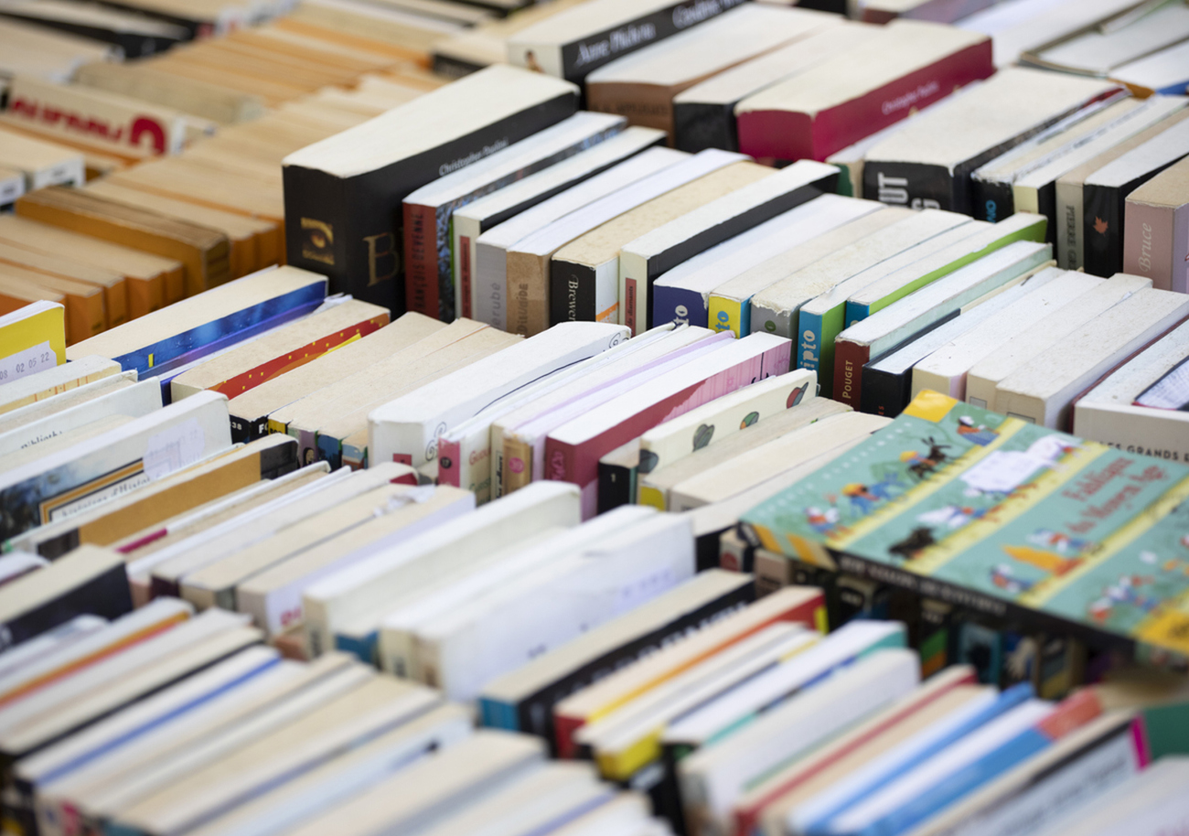 Trays of used books for sale outside a bookstore