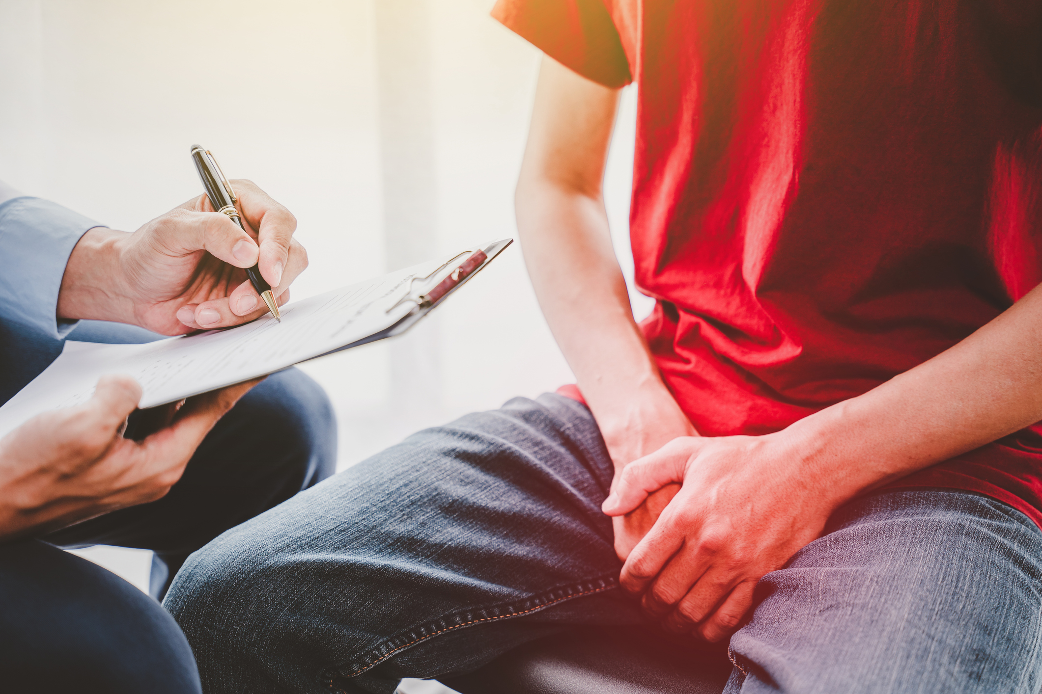 Urologist Doctor giving consult for prostate problems to patient. Urologic oncologists specialize in treating cancer of the urinary tract and male reproductive organs. Mens health problem concept.