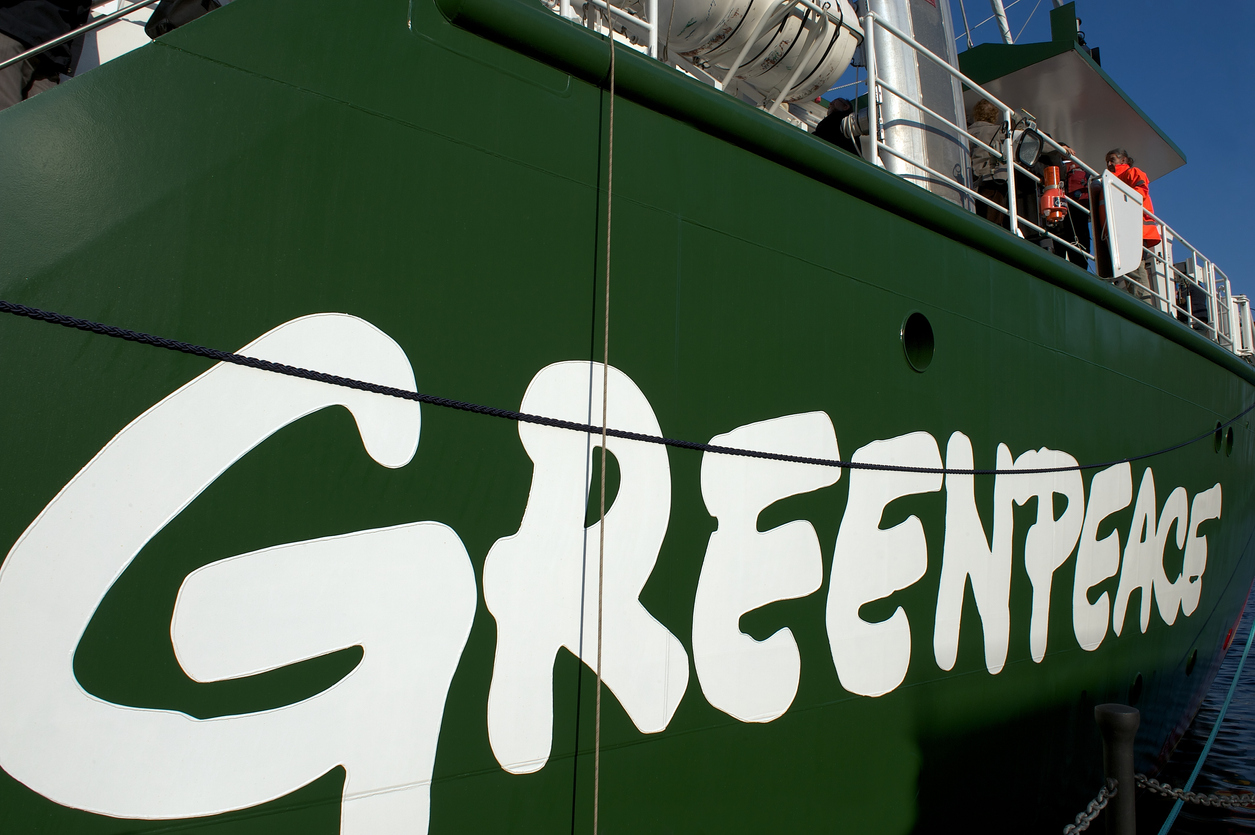 London, United Kingdom - November 13 2011: Rainbow Warrior III name and logo on side of Greenpeace's ship with members of the public visiting it on its open day in London.