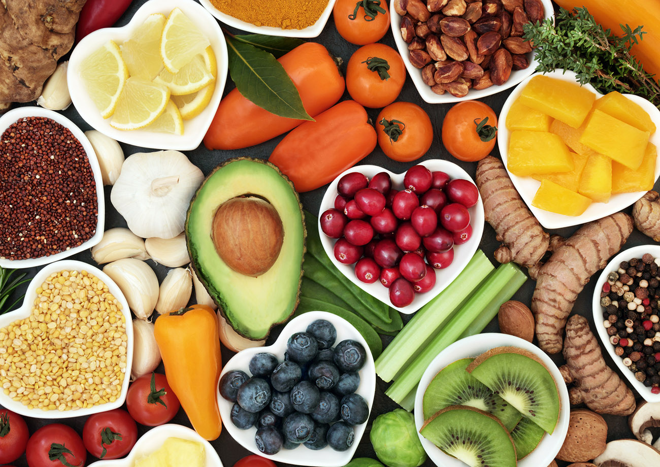 Health food for fitness concept with fresh fruit, vegetables, pulses, herbs, spices, nuts, grains and pulses. High in anthocyanins, antioxidants,smart carbohydrates, omega 3 fatty acids,  minerals and vitamins.