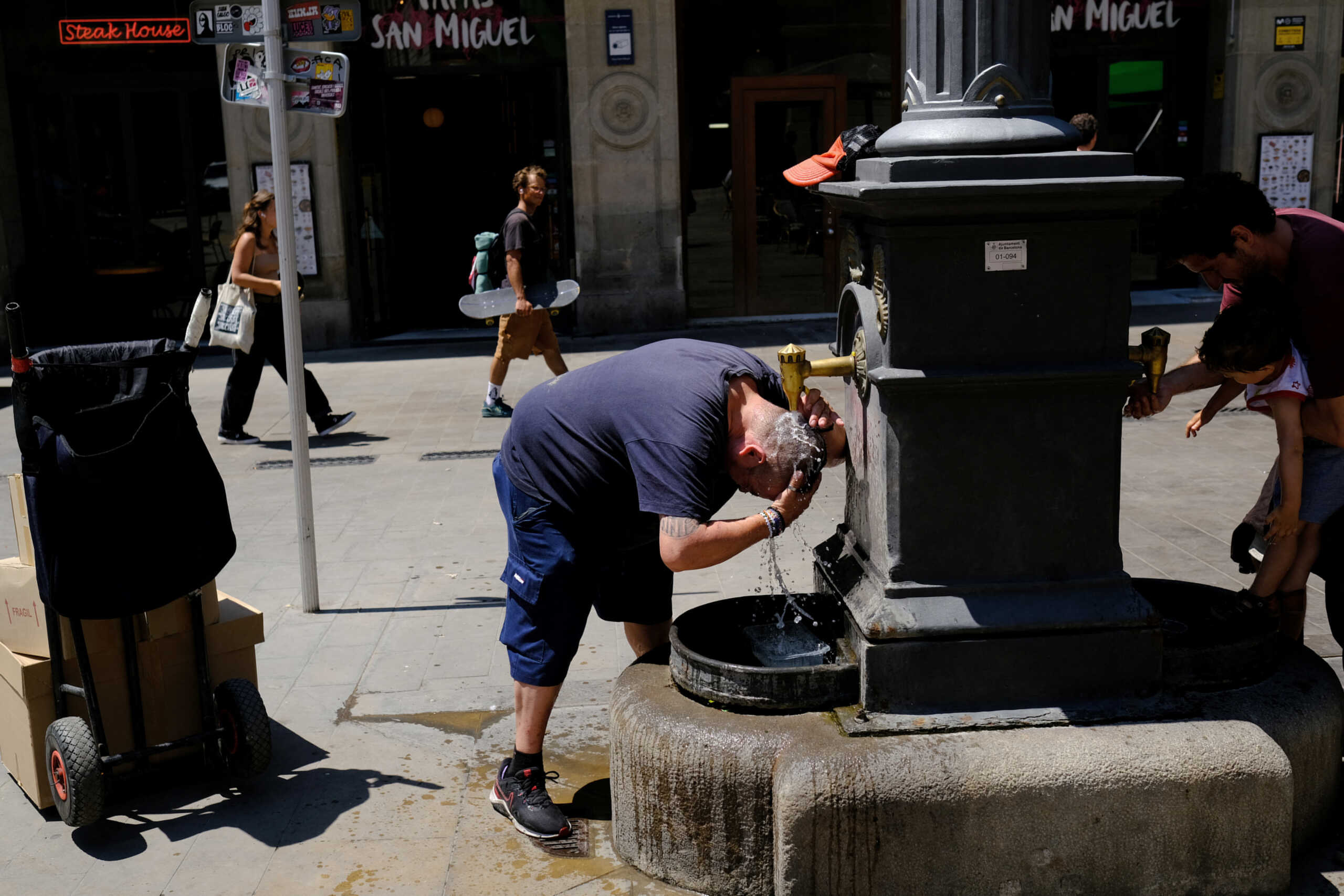 Xavi, 50, who is a door-to-door parcel delivery man, cools himself in a fountain during his work, ahead of first summer heatwave in the centre of Barcelona, Spain June 26, 2023. REUTERS