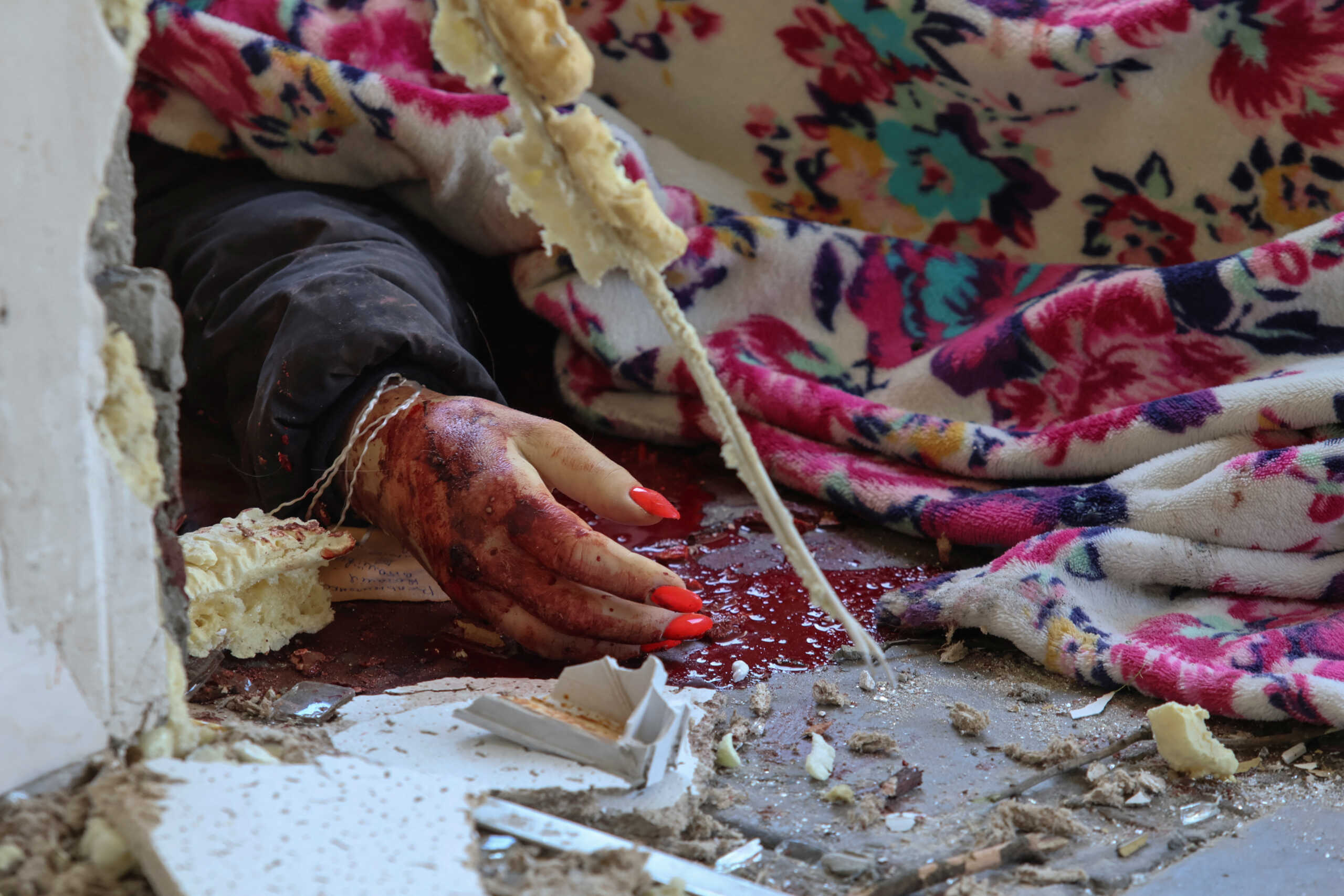 SENSITIVE MATERIAL. THIS IMAGE MAY OFFEND OR DISTURB The hand of local resident Natalia who was killed during a Russian missile strike is seen at a compound of a municipal clinic, amid Russia's attack on Ukraine, in Kyiv, Ukraine June 1, 2023. REUTERS