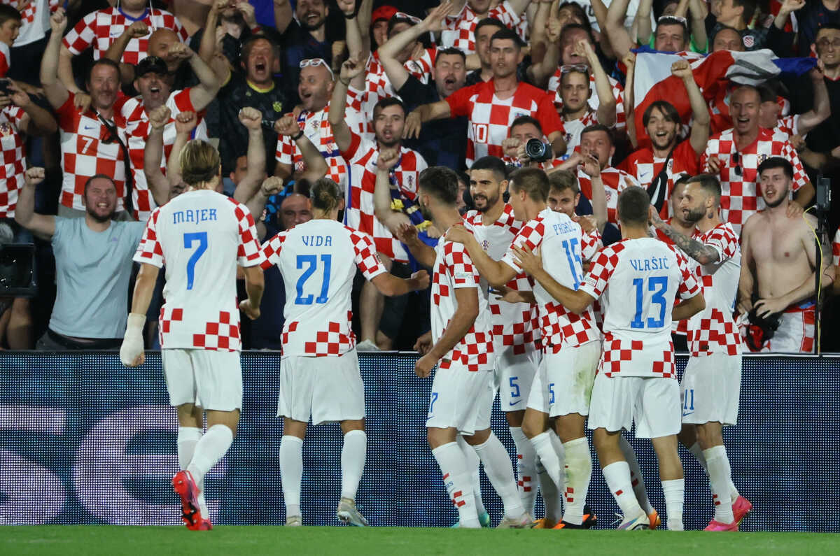Soccer Football - UEFA Nations League - Semi Final - Netherlands v Croatia - Feyenoord Stadium, Rotterdam, Netherlands - June 14, 2023 Croatia's Bruno Petkovic celebrates scoring their third goal with teammates and fans REUTERS