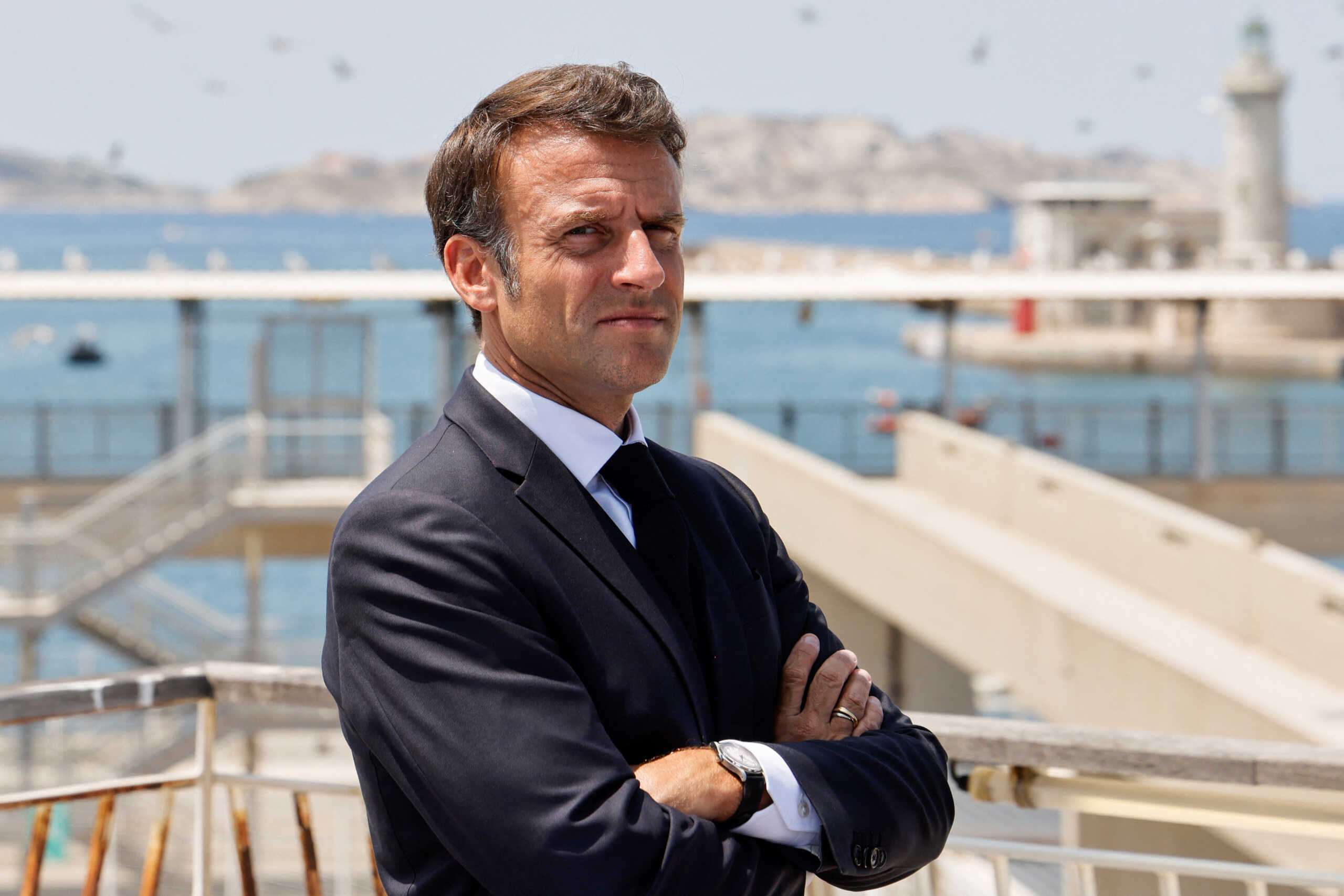 French President Emmanuel Macron looks on, as he visits the Marseille-Fos industrial dock in Marseille, southeastern France, on June 28, 2023. The French president is on a three-day visits to Marseille from June 26 to 28, two years after launching a transformation plan for the city. In September 2021 he promised five billion euros (5.5 billion USD) to hire new police, renovate schools and public spaces and upgrade the creaking public transport network.     LUDOVIC MARIN