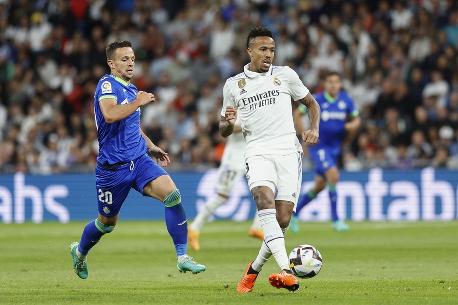epa10626076 Real Madrid's Brazilian defender Eder Militao (R) in action against Getafe's midfielder Nemanja Maksimovic (L) during the Spanish LaLiga soccer match between Real Madrid and Getafe CF at Santiago Bernabeu Stadium in Madrid, Spain, 13 May 2023.  EPA