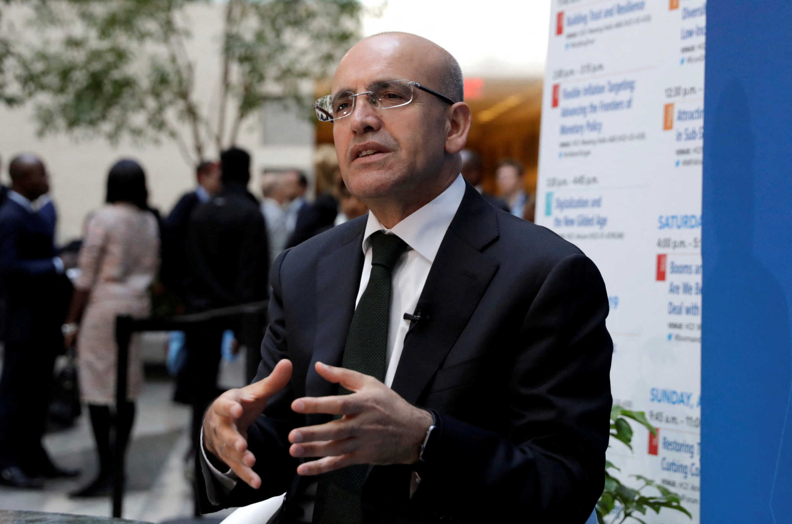 FILE PHOTO: Turkish Deputy Prime Minister Mehmet Simsek speaks during a television interview after IMFC plenary the IMF