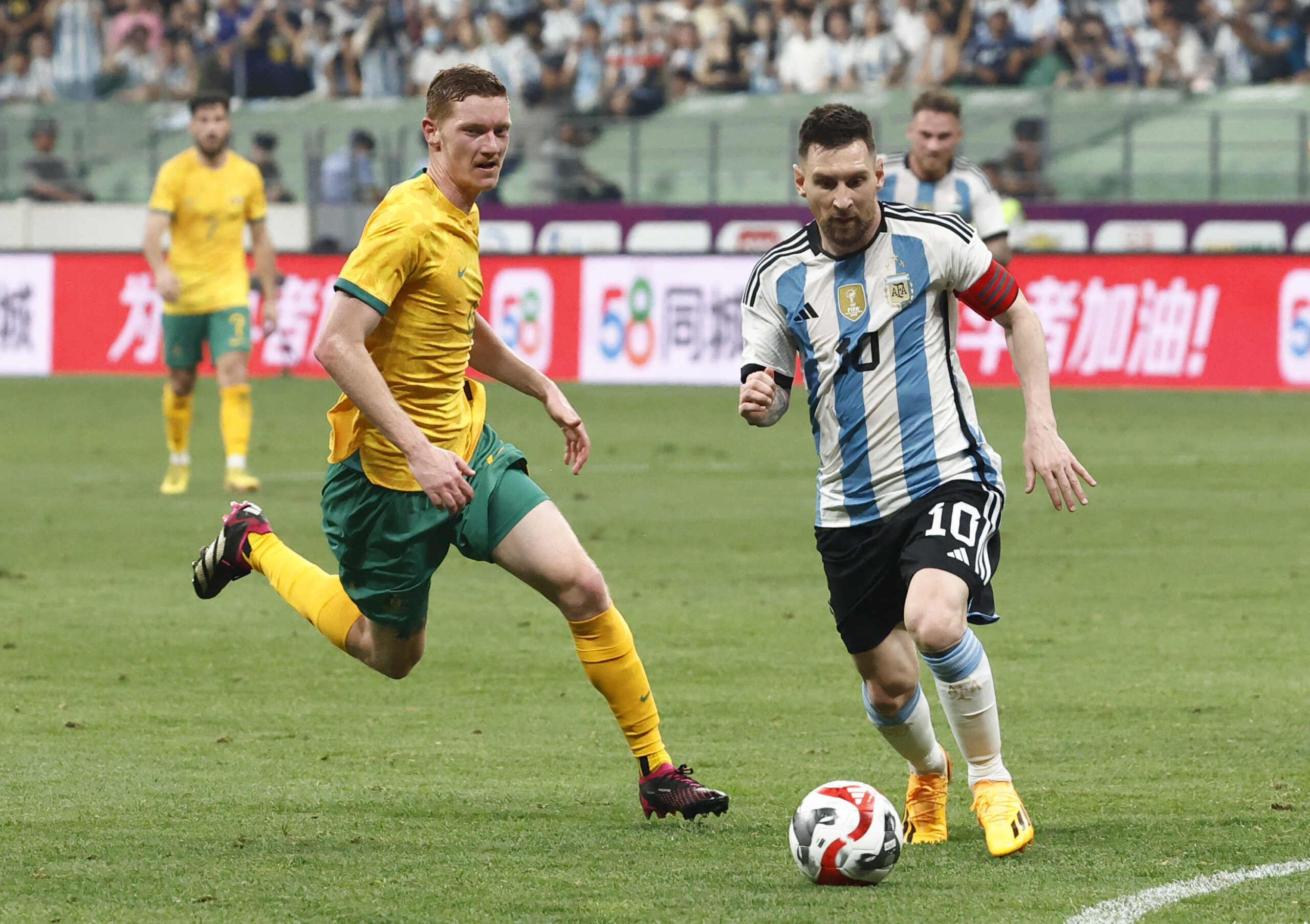 Soccer Football - Friendly - Argentina v Australia - Workers' Stadium, Beijing, China - June 15, 2023 Argentina's Lionel Messi in action with Australia's Kye Rowles REUTERS
