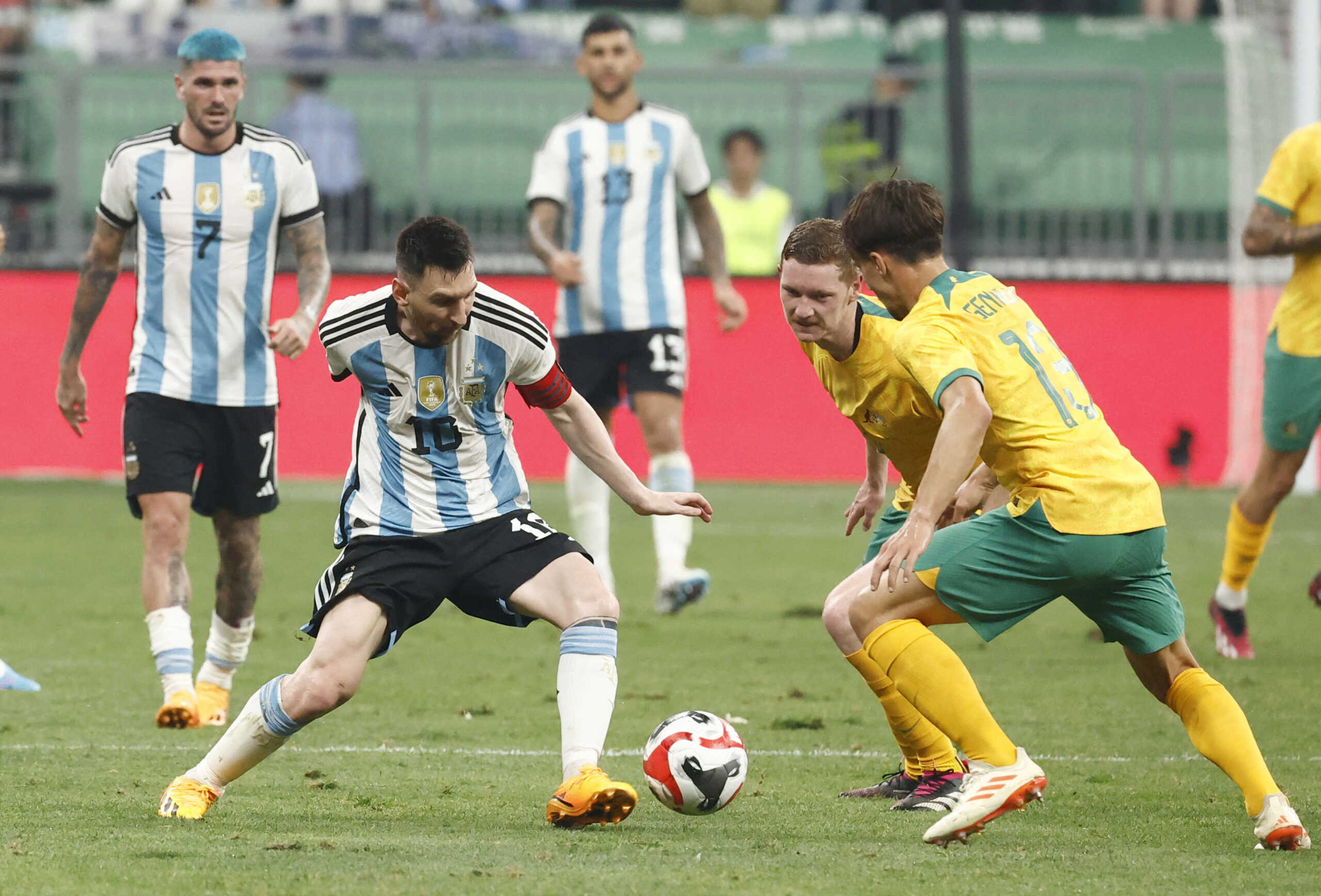 Soccer Football - Friendly - Argentina v Australia - Workers' Stadium, Beijing, China - June 15, 2023 Argentina's Lionel Messi in action with Australia's Kye Rowles and Denis Genreau REUTERS