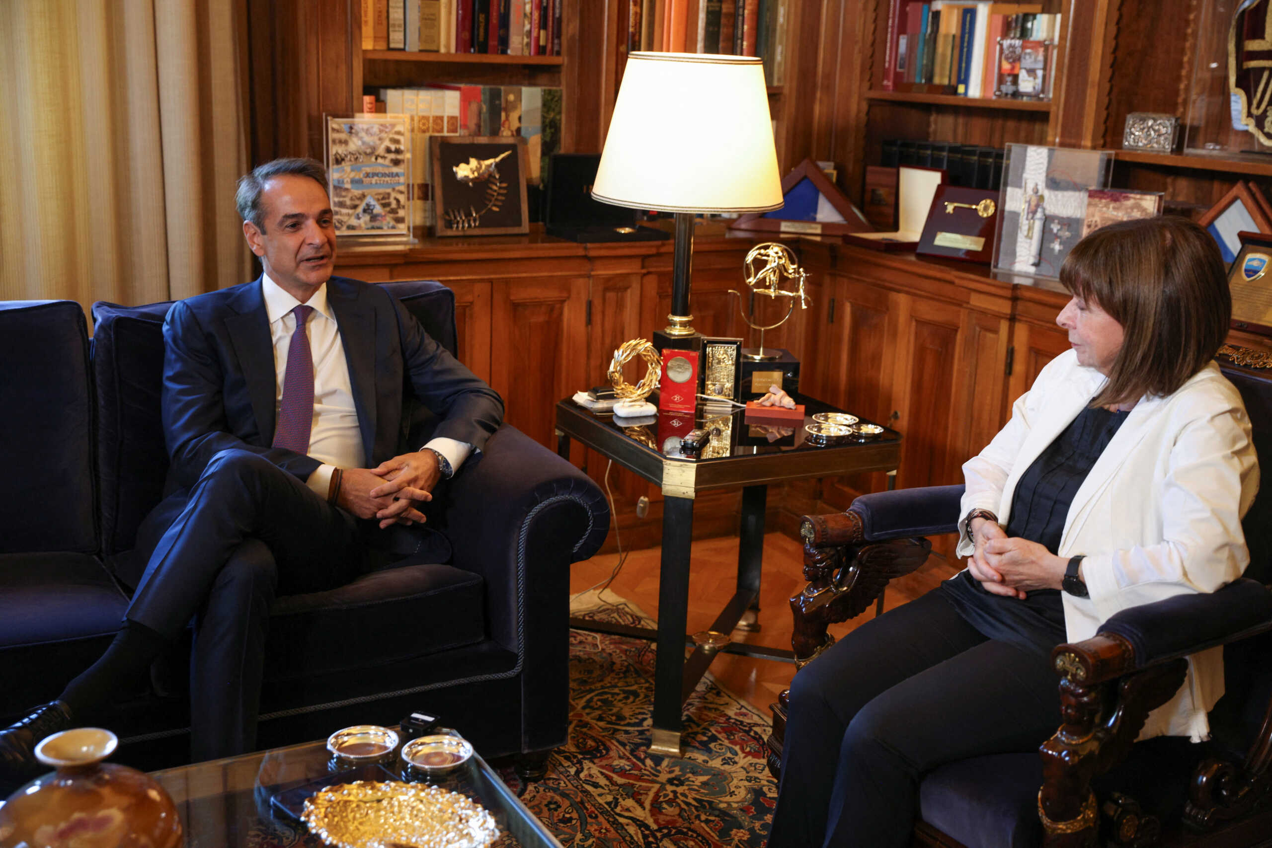 Newly elected Greek Prime Minister and leader of New Democracy conservative party Kyriakos Mitsotakis speaks with President Katerina Sakellaropoulou at the Presidential Palace, following a general election, in Athens, Greece, June 26, 2023. REUTERS