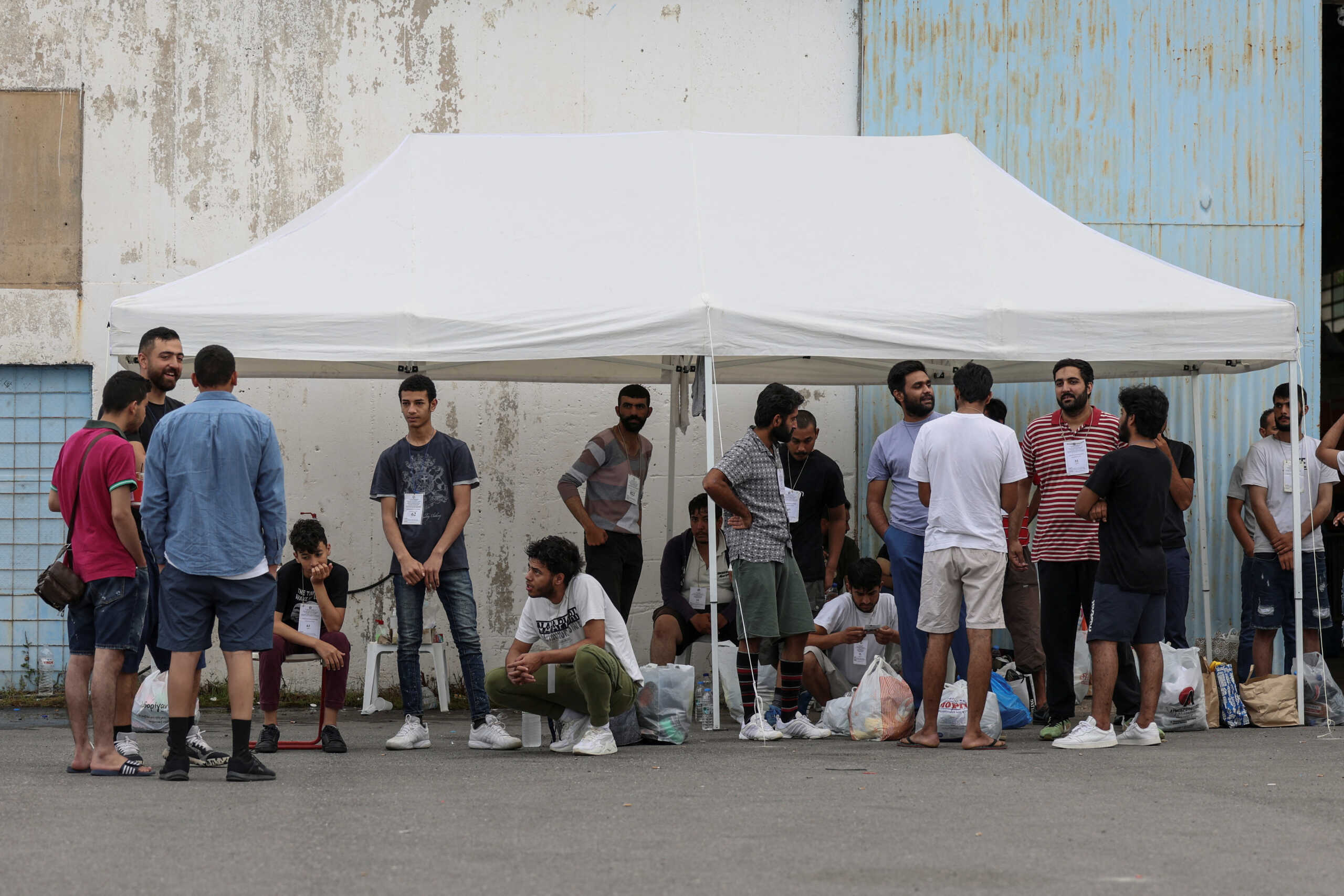 Migrants, survivors of a deadly shipwreck after a boat capsized at open sea off Greece, wait to board a bus as they are being transferred to Athens from the port of Kalamata, Greece, June 16, 2023. REUTERS