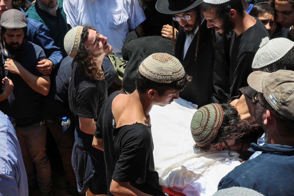 Mourners attend the funeral of 17-year-old Nachman Shmuel Mordoff, who was killed in a Palestinian shooting attack along with three other Israelis near the Jewish settlement of Eli, in Shilo in the Israeli-occupied West Bank June 21, 2023. REUTERS