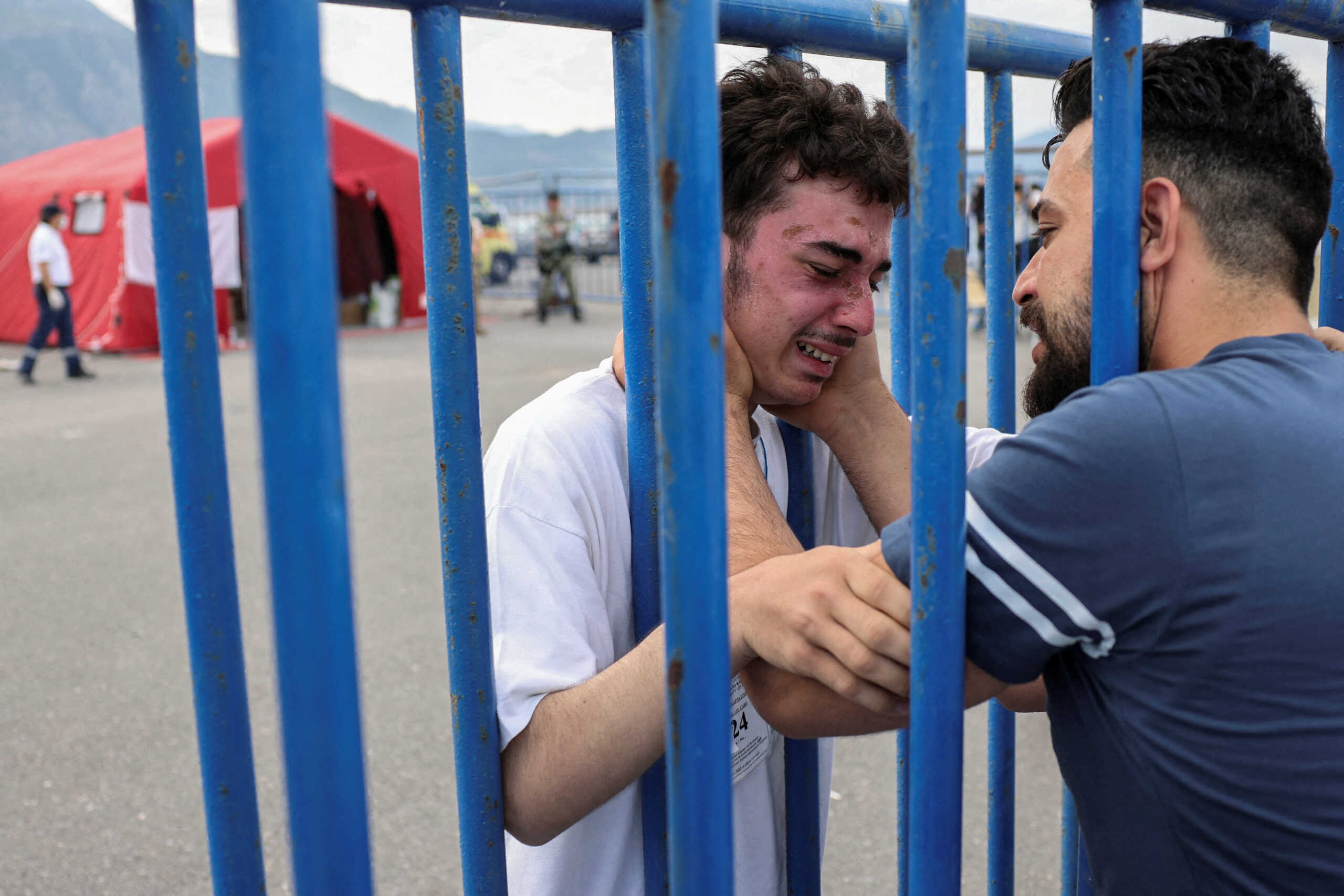 Syrian survivor Fedi, 18, who was rescued with other refugees and migrants at open sea off Greece after their boat capsized, cries as he reunites with his brother Mohammad, who came to meet him from Italy, at the port of Kalamata, Greece, June 16, 2023. REUTERS