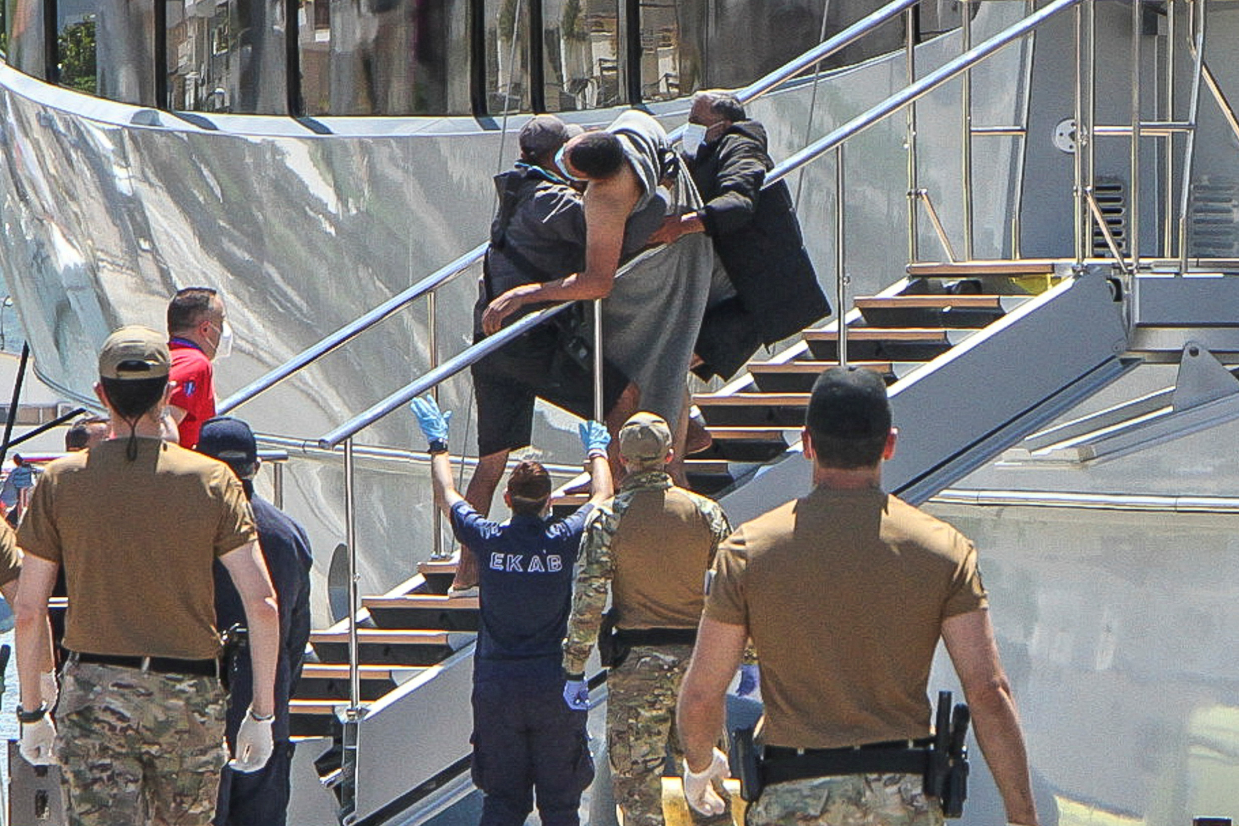 A migrant is helped as he and other migrants arrive at the port of Kalamata, following a rescue operation, after their boat capsized on the open sea, in Kalamata, Greece, June 14, 2023. Eurokinissi via REUTERS ATTENTION EDITORS - THIS IMAGE HAS BEEN SUPPLIED BY A THIRD PARTY. NO RESALES. NO ARCHIVES. NO EDITORIAL USE IN GREECE.