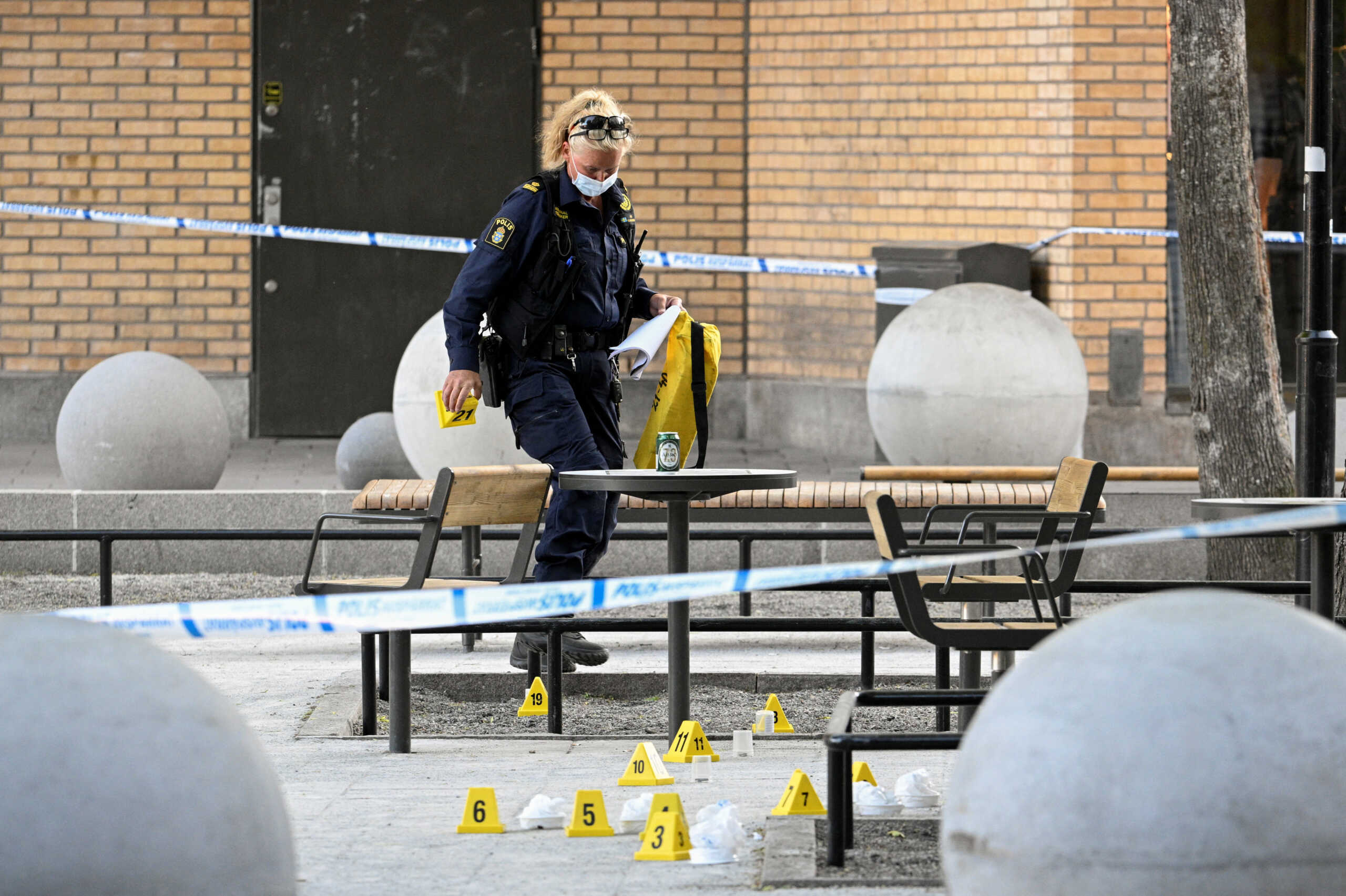 Police officers work at a site, following a shooting in Farsta, southern Stockholm, Sweden, June 10, 2023. Anders Wiklund