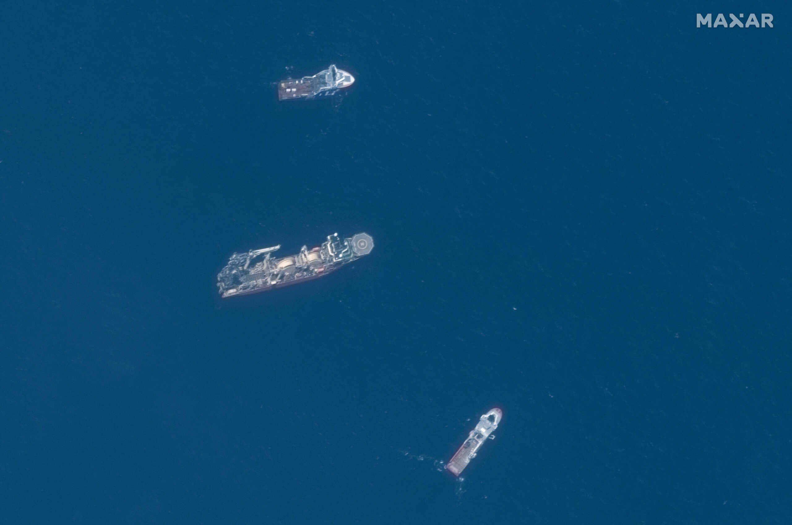 A satellite image shows ships taking part in the search and rescue operations associated with the missing Titan submersible near the wreck of the Titanic,  June 22, 2023. Maxar Technologies
