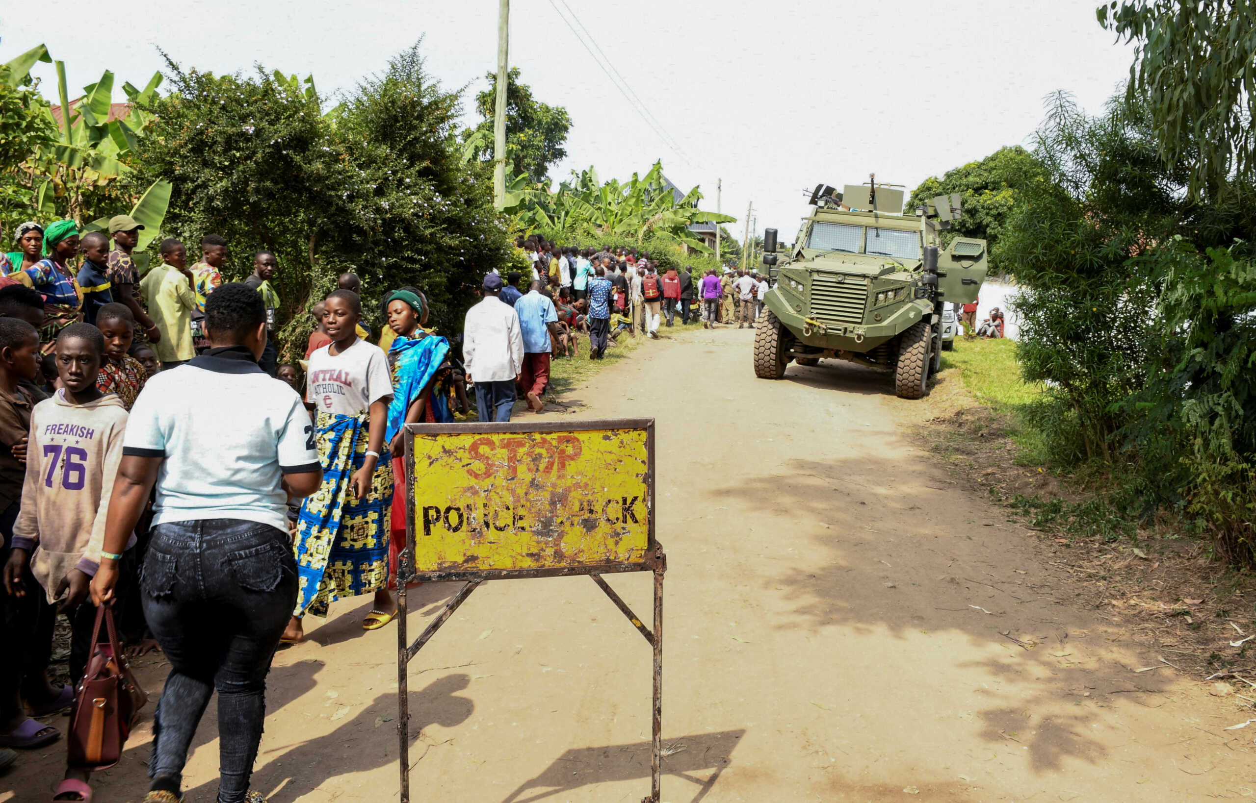 Locals gather at the cordoned scene outside the Mpondwe Lhubirira Secondary School, after militants linked to rebel group Allied Democratic Forces (ADF) killed and abducted multiple people, in Mpondwe, western Uganda, June 17, 2023. REUTERS